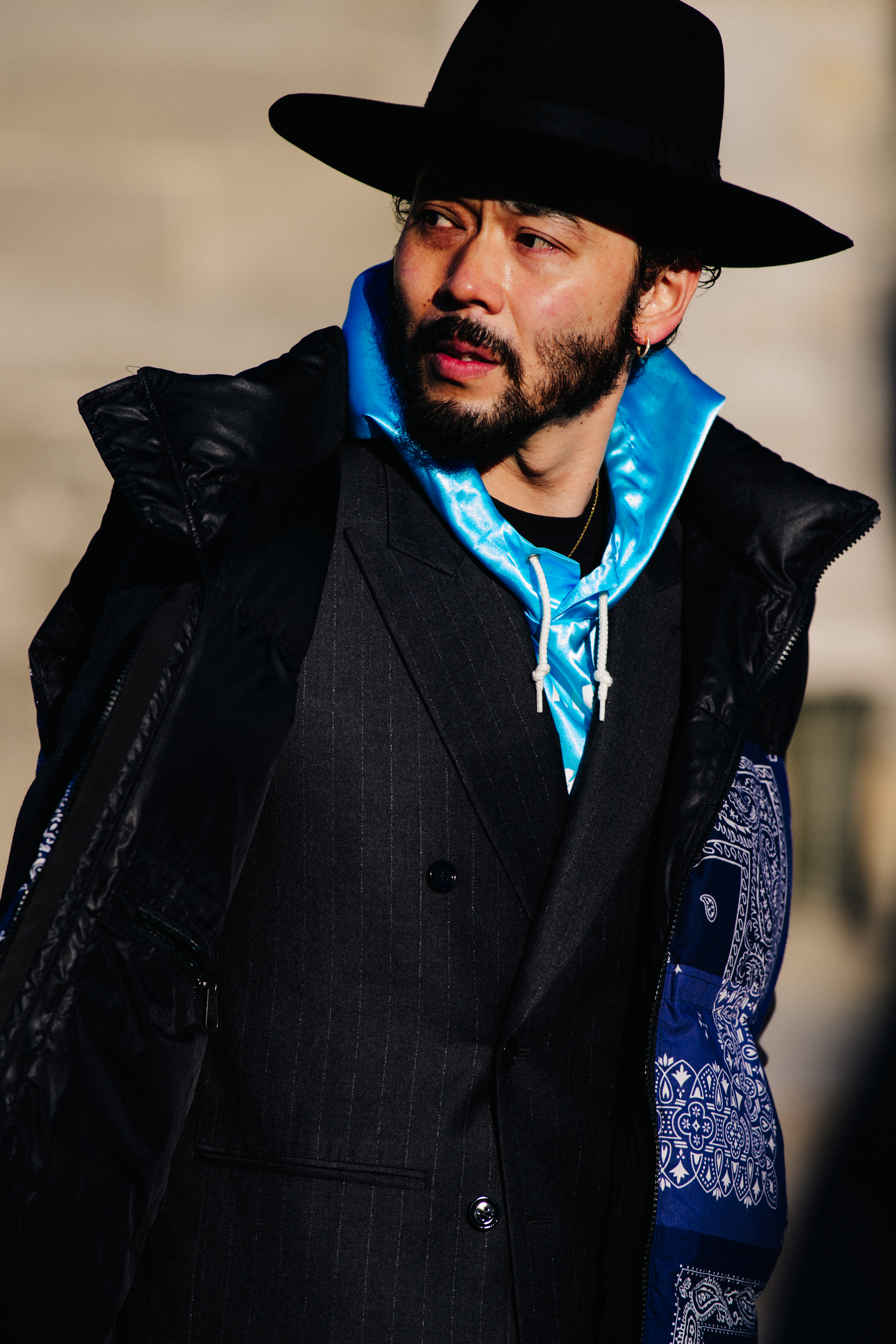 Man wearing blue shiny hoodie