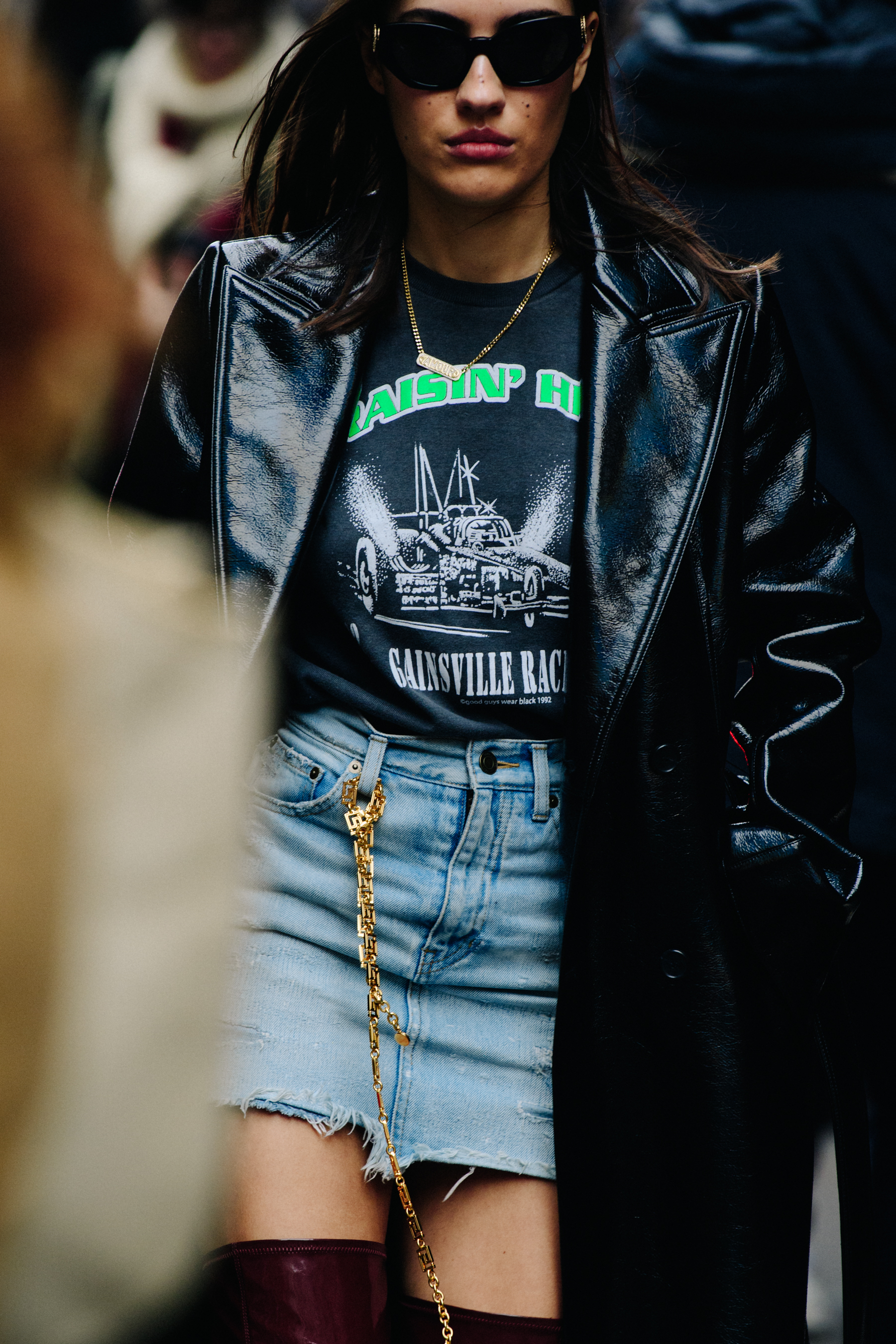Woman wearing black plastic jacket