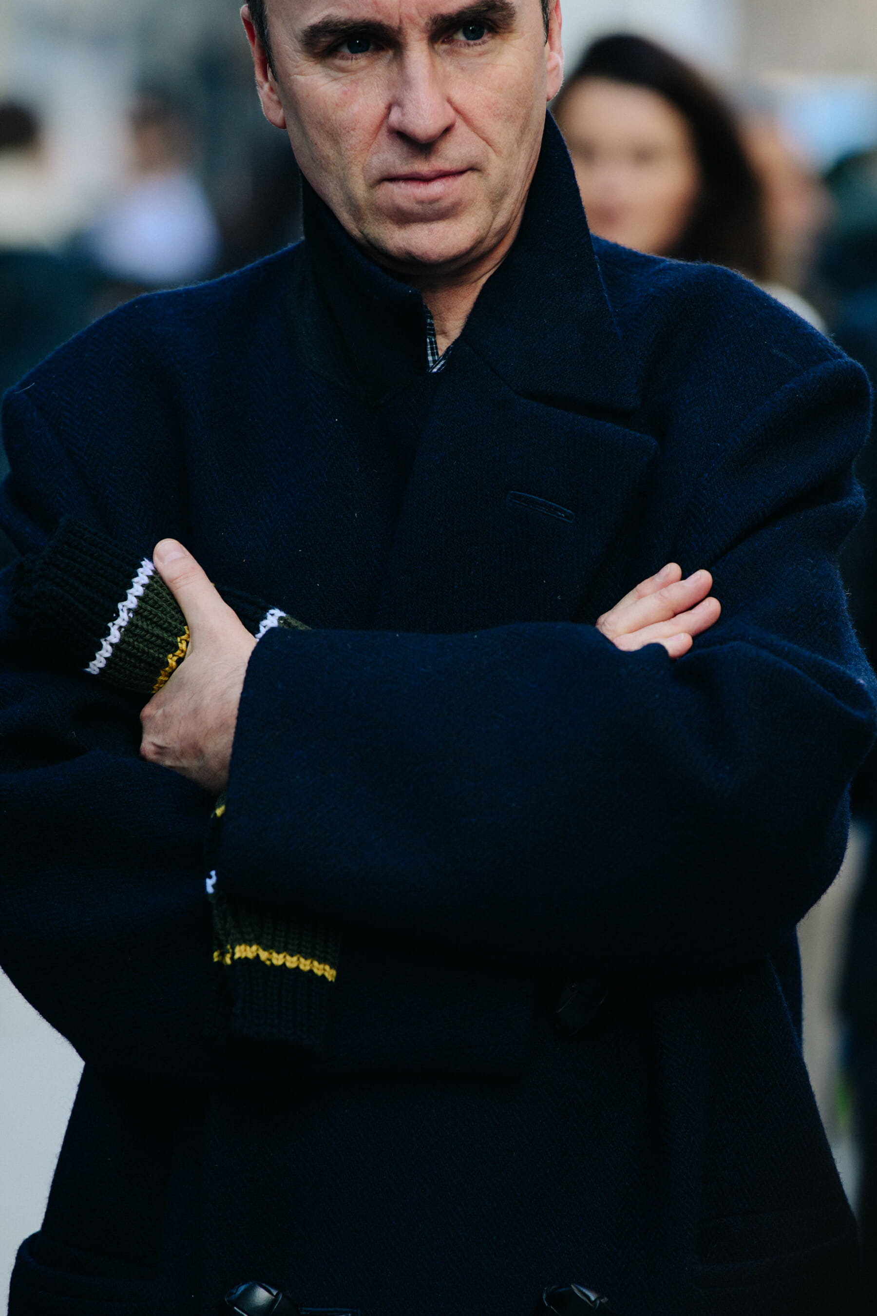 Designer wearing navy coat