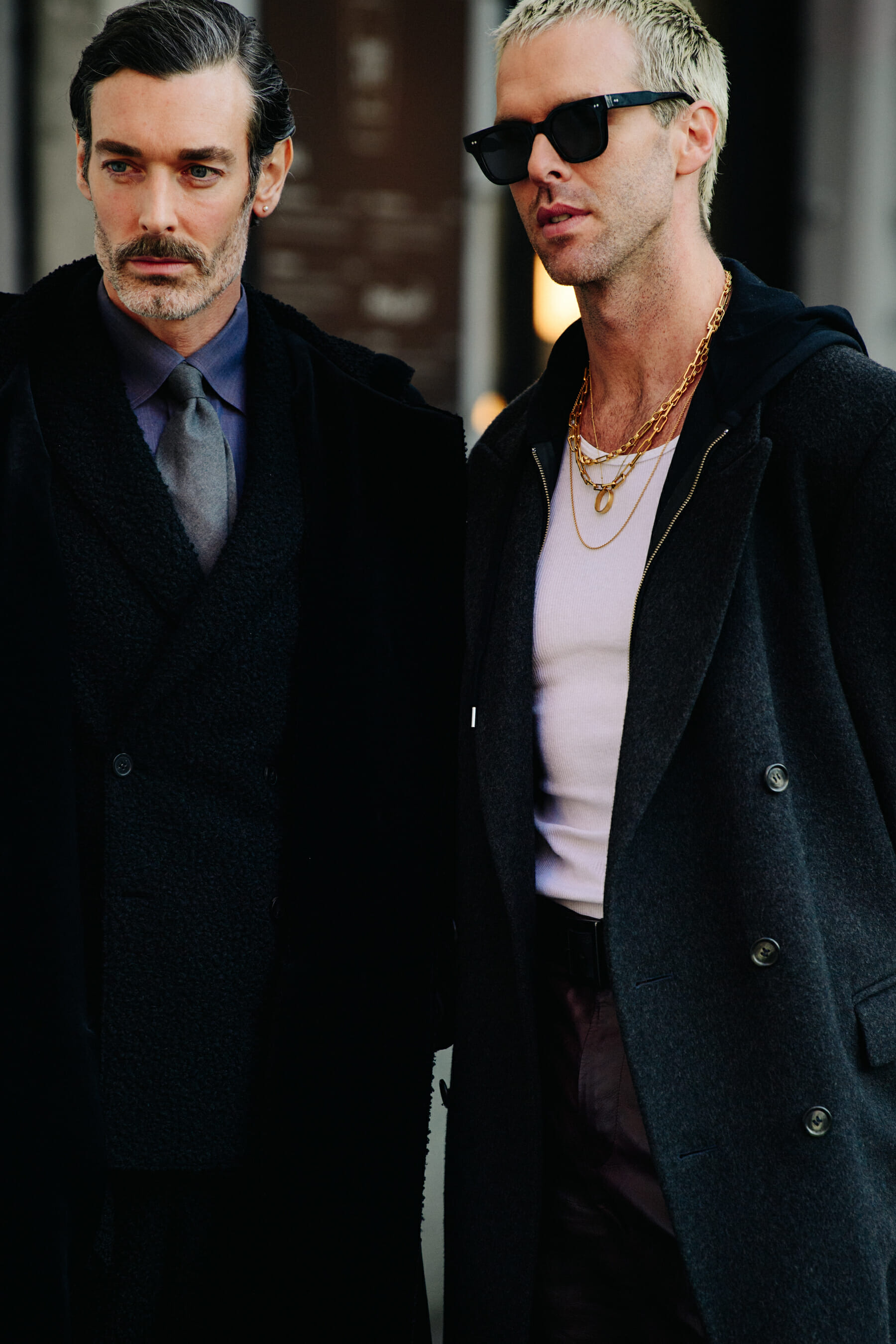 Two men wearing dark wool coats