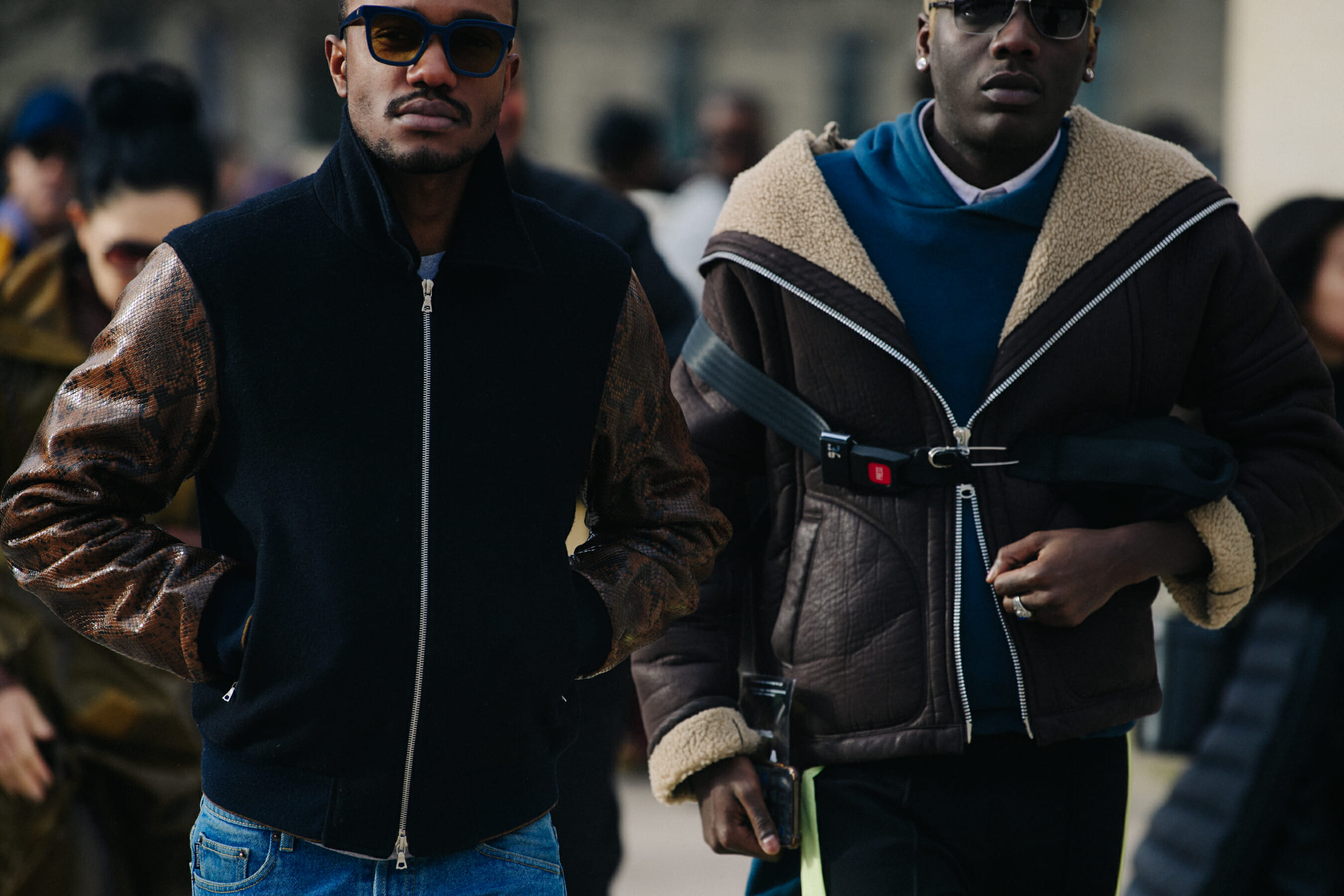 Two men wearing brown jackets