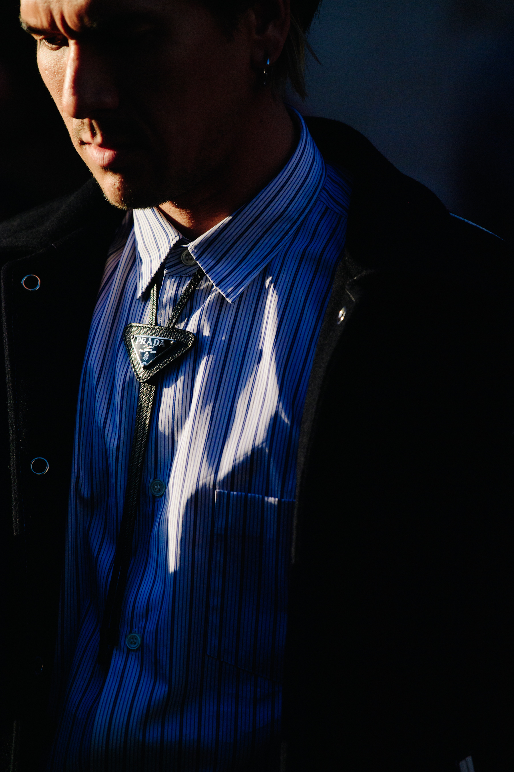 Man wearing Prada necklace