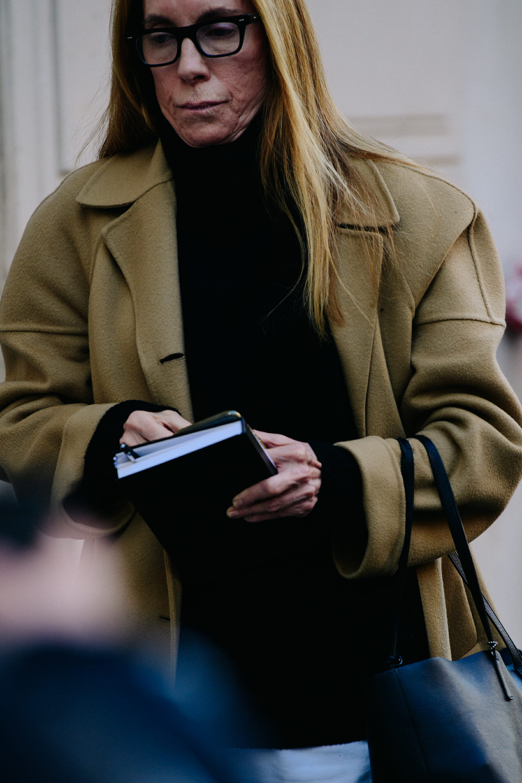 Woman wearing tan coat