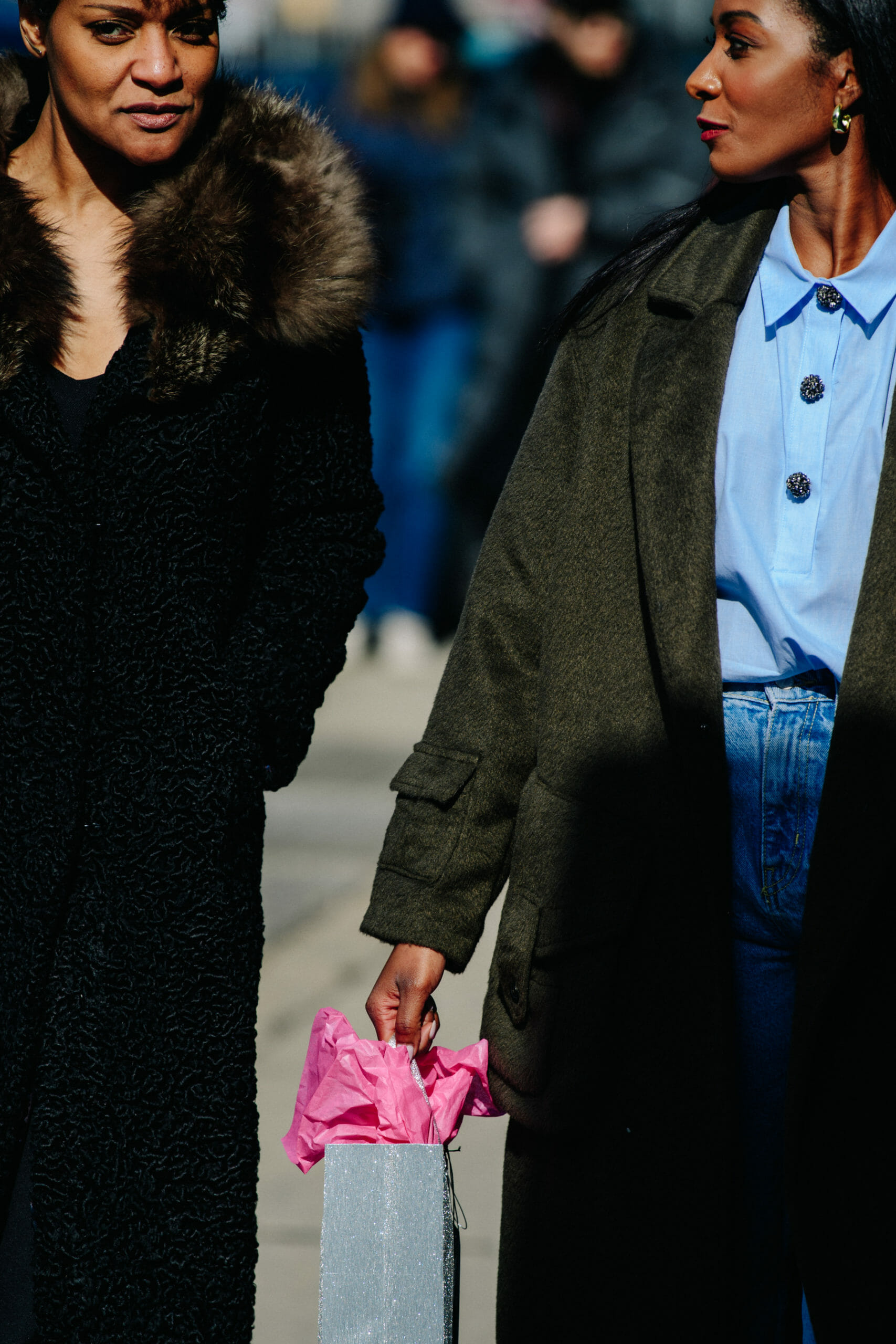 Two women wearing dark coats