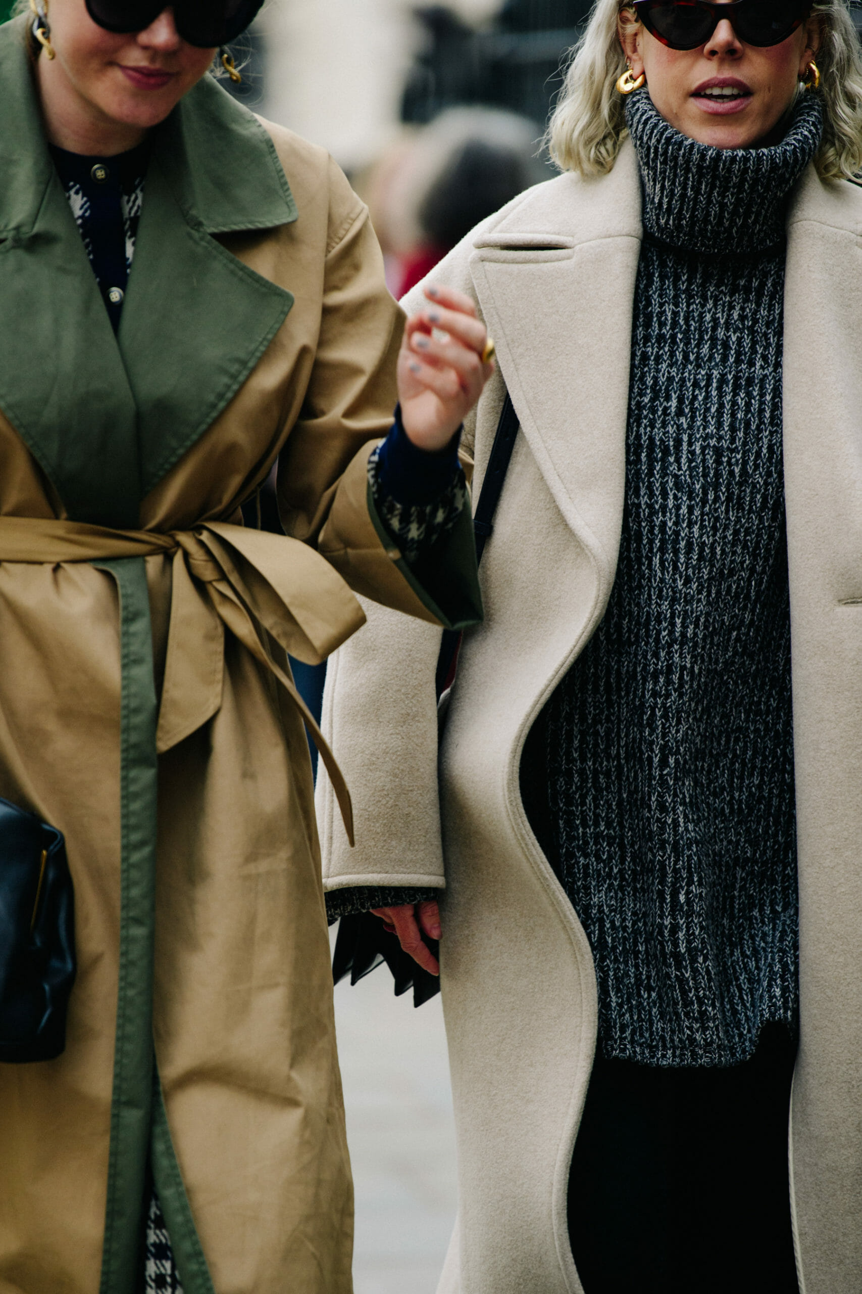 Two women wearing long coats