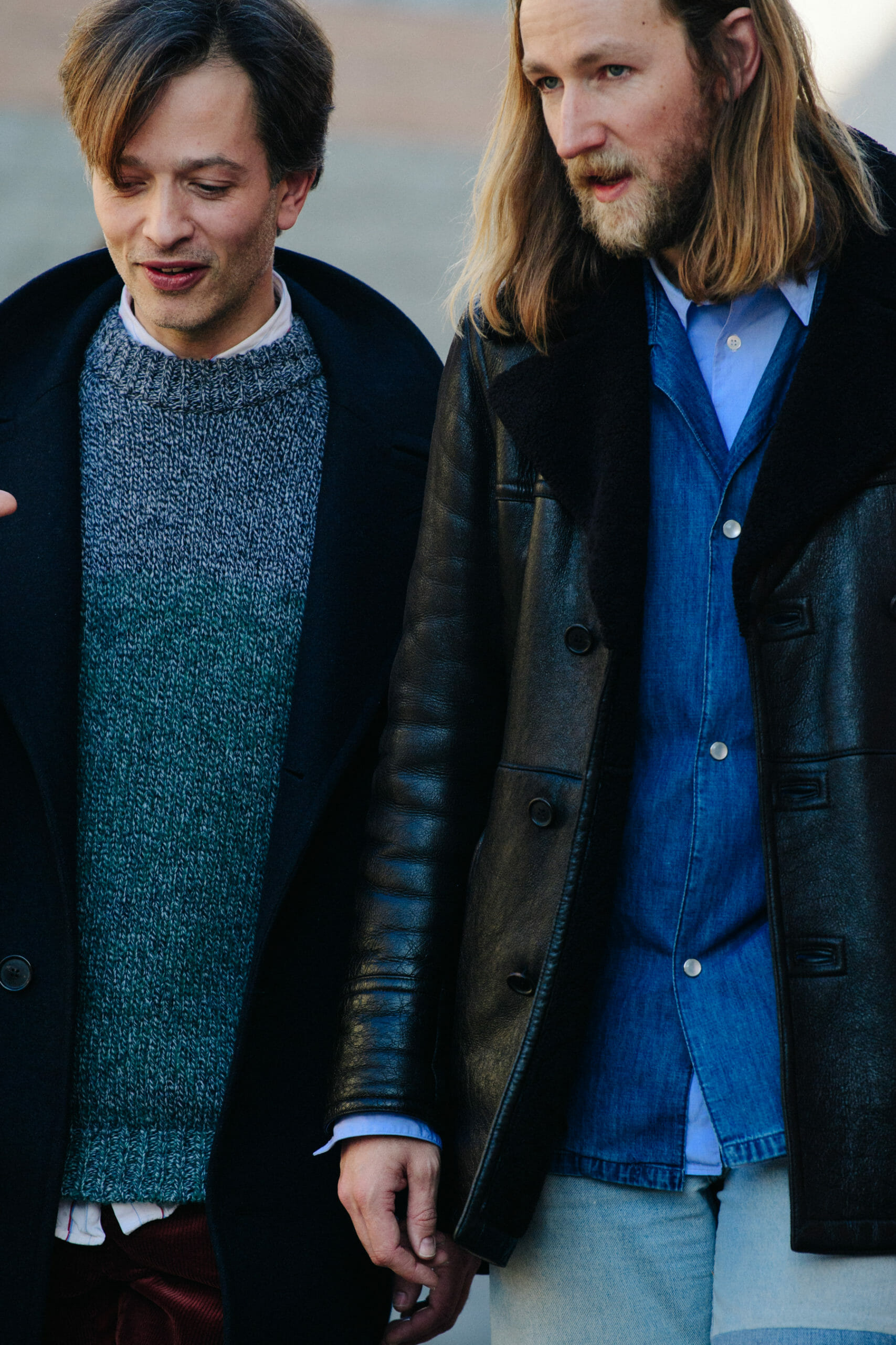 Two men wearing dark coats