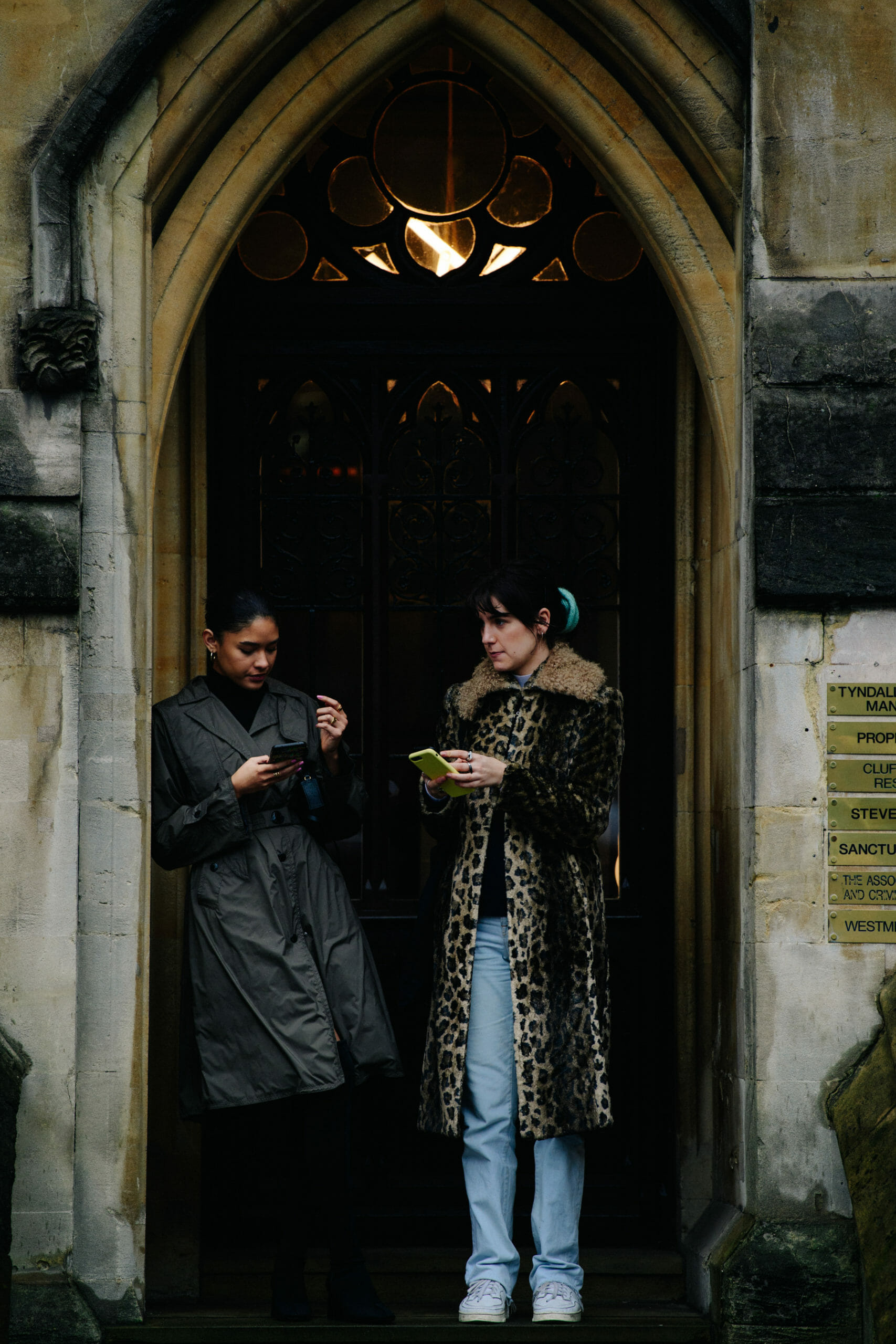 Two women wearing long coats