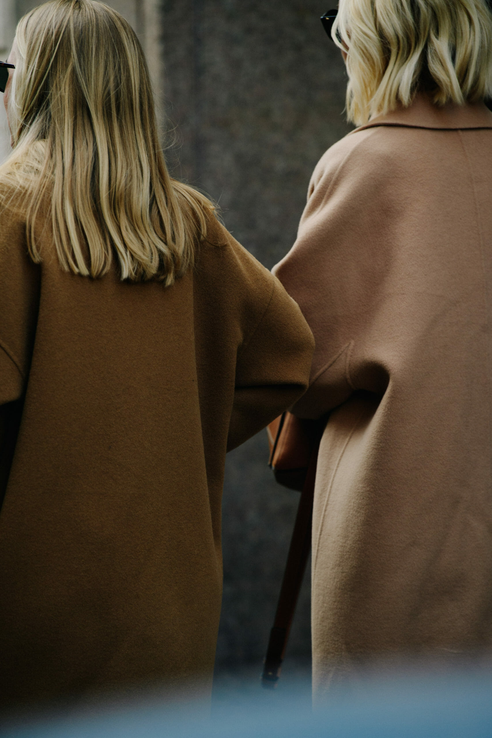 Women wearing tan coats