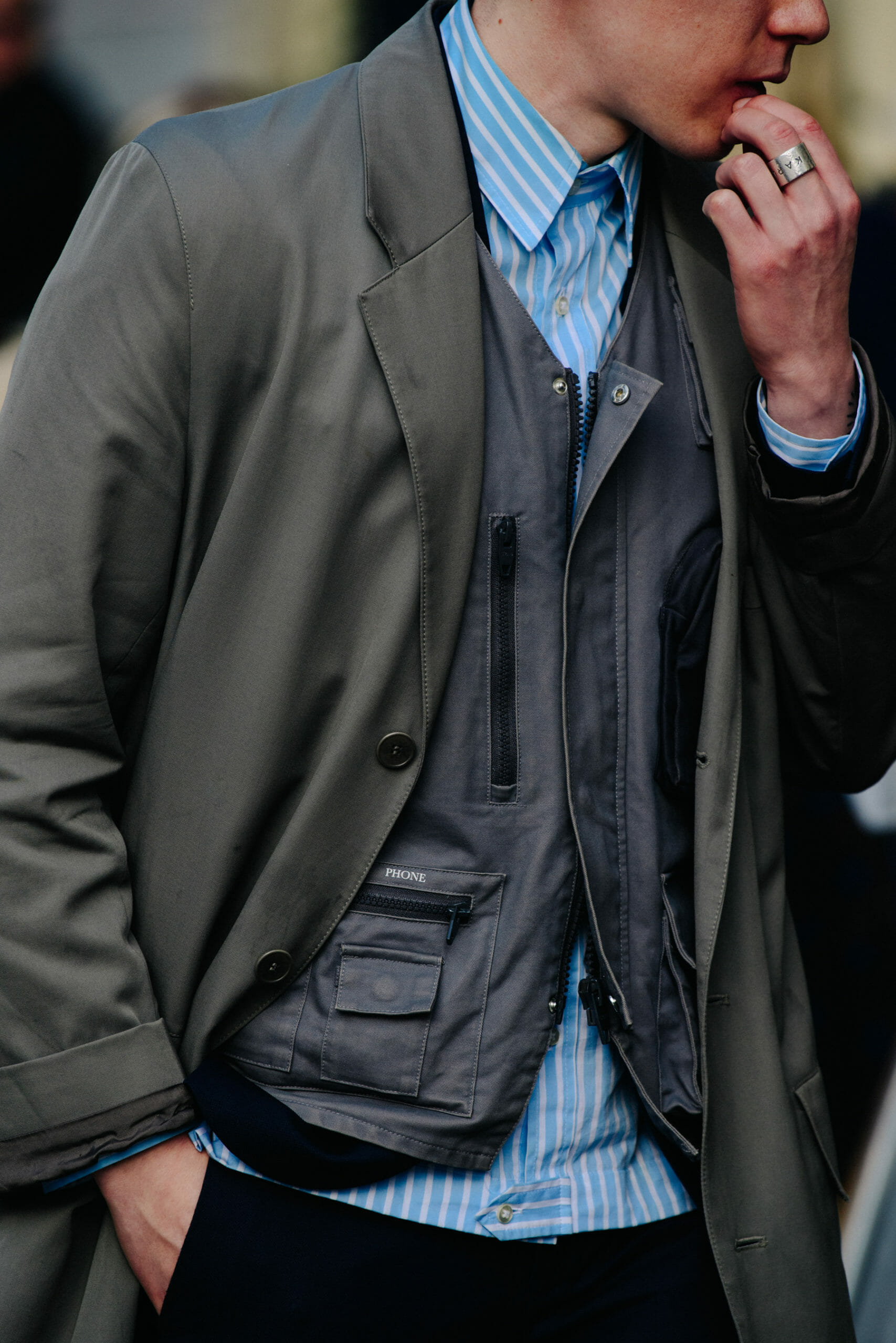 Man wearing grey vest