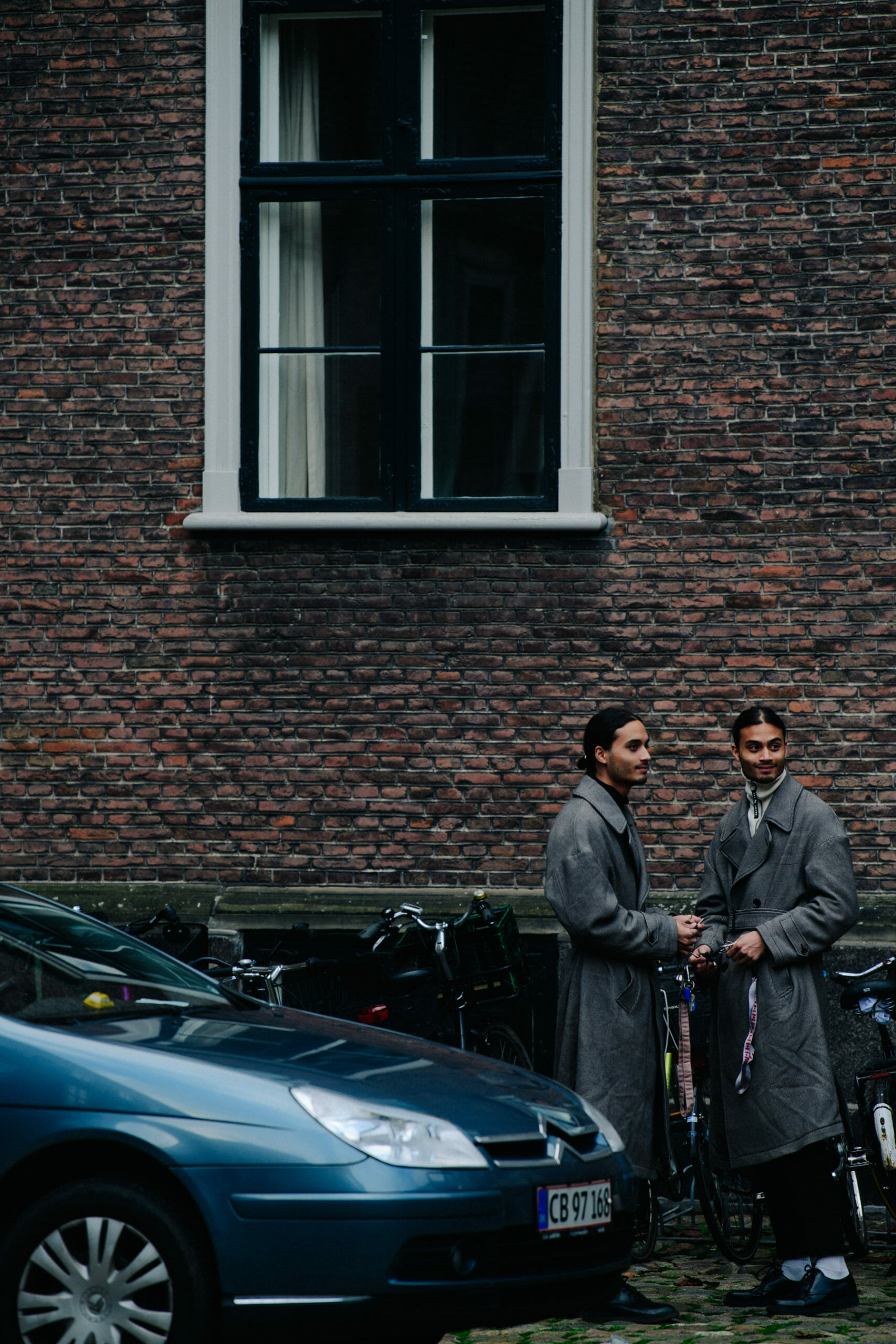 Twins wearing grey coats