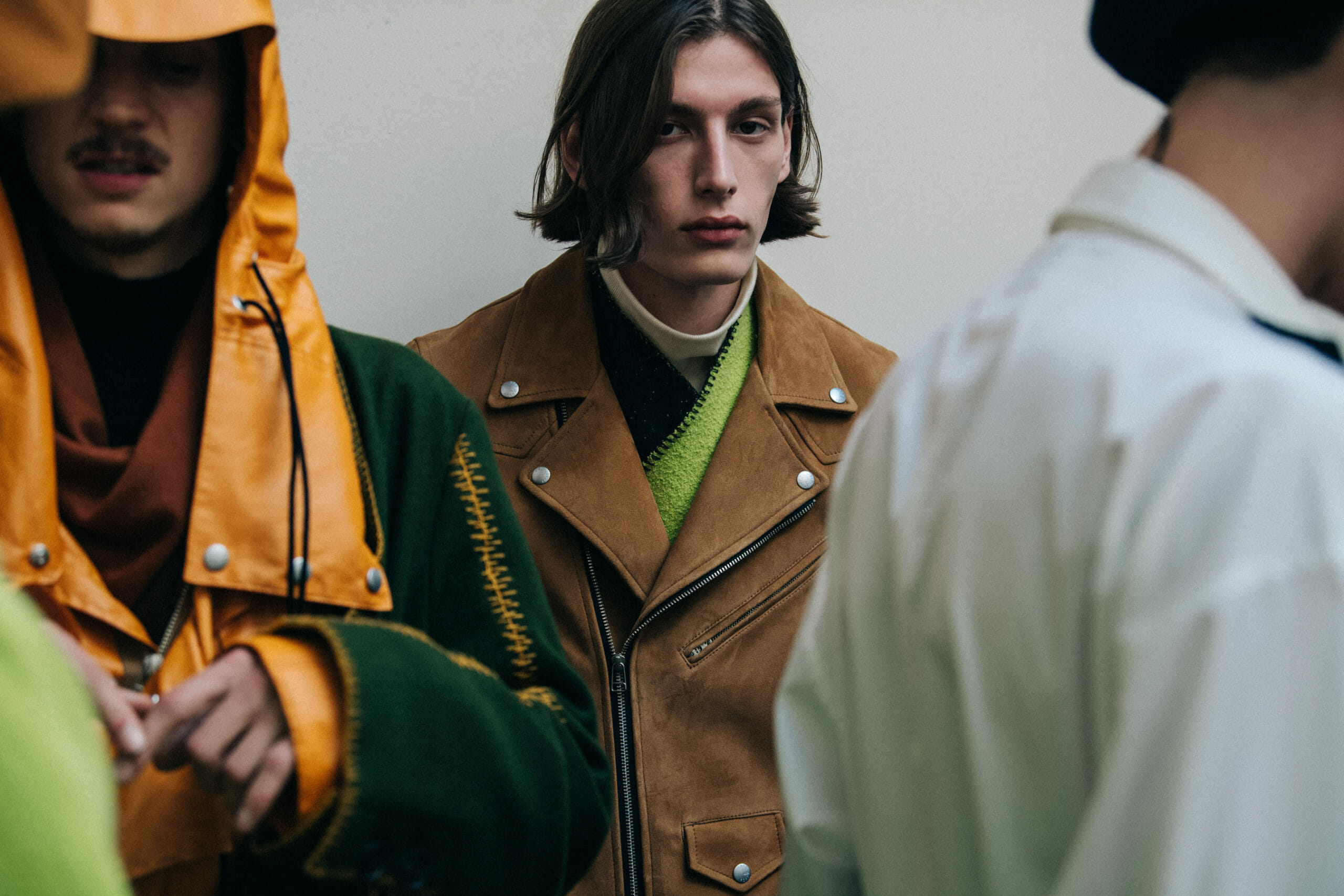 Models wearing orange and green