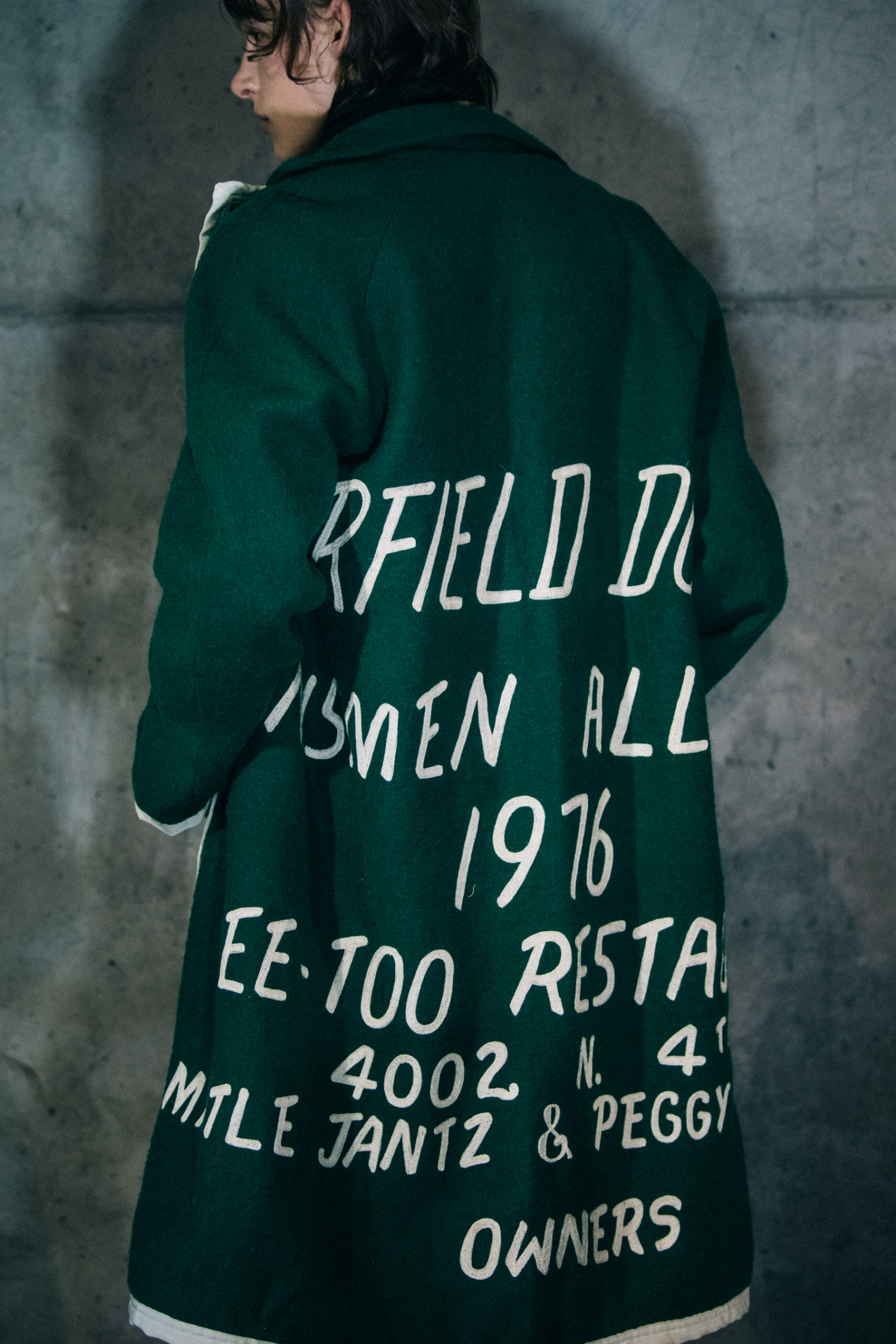 Model wearing green Bode coat