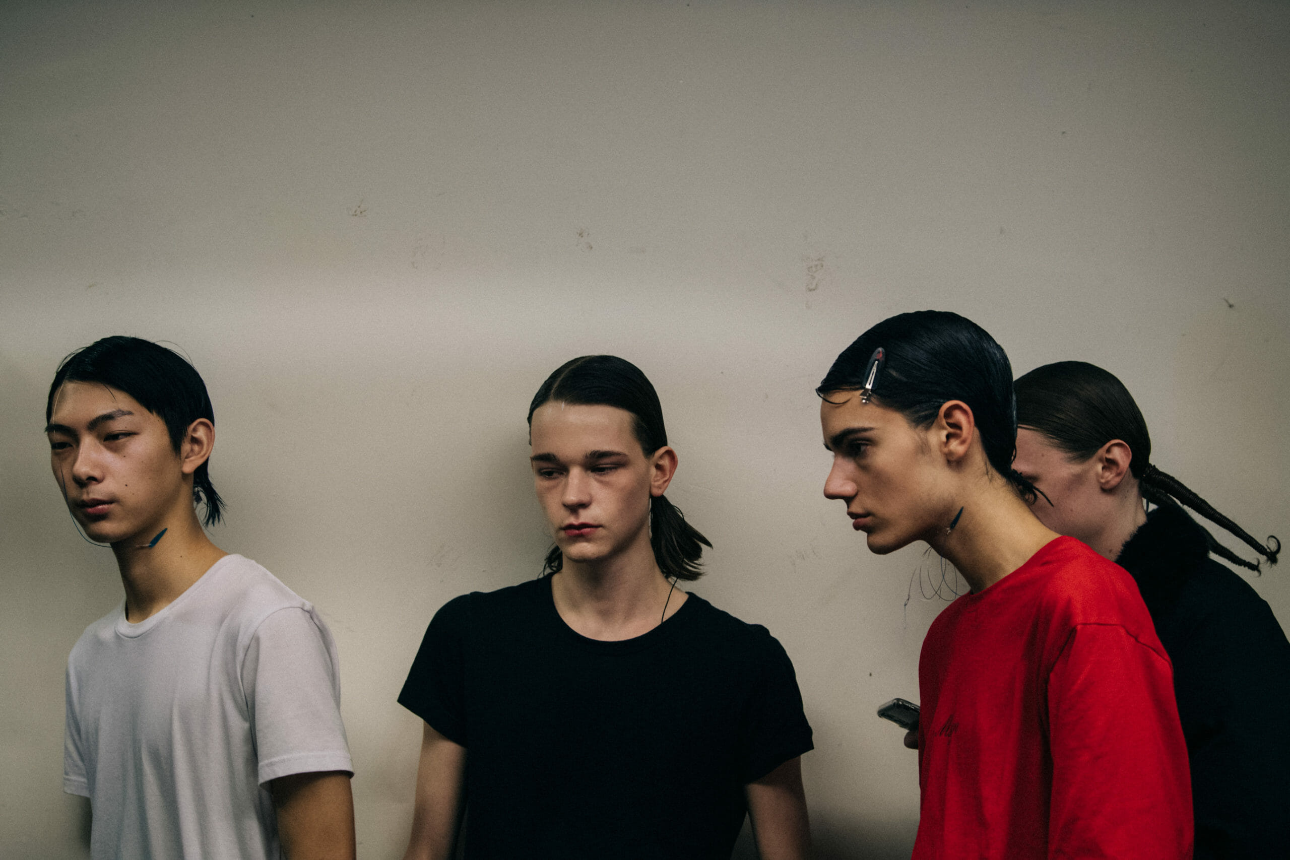 Models wearing red Kiko Kostadinov outfits