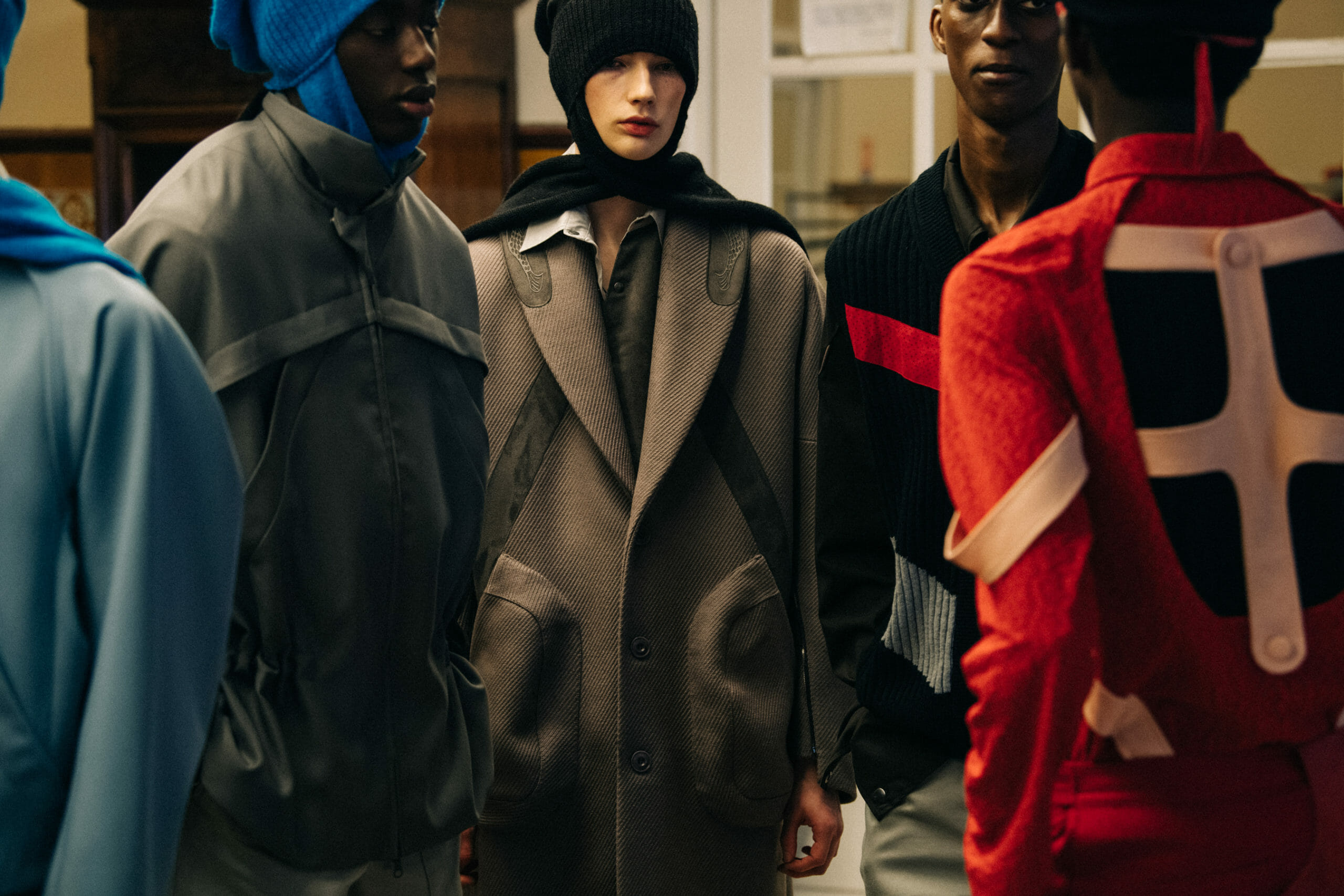 Models wearing red Kiko Kostadinov outfits