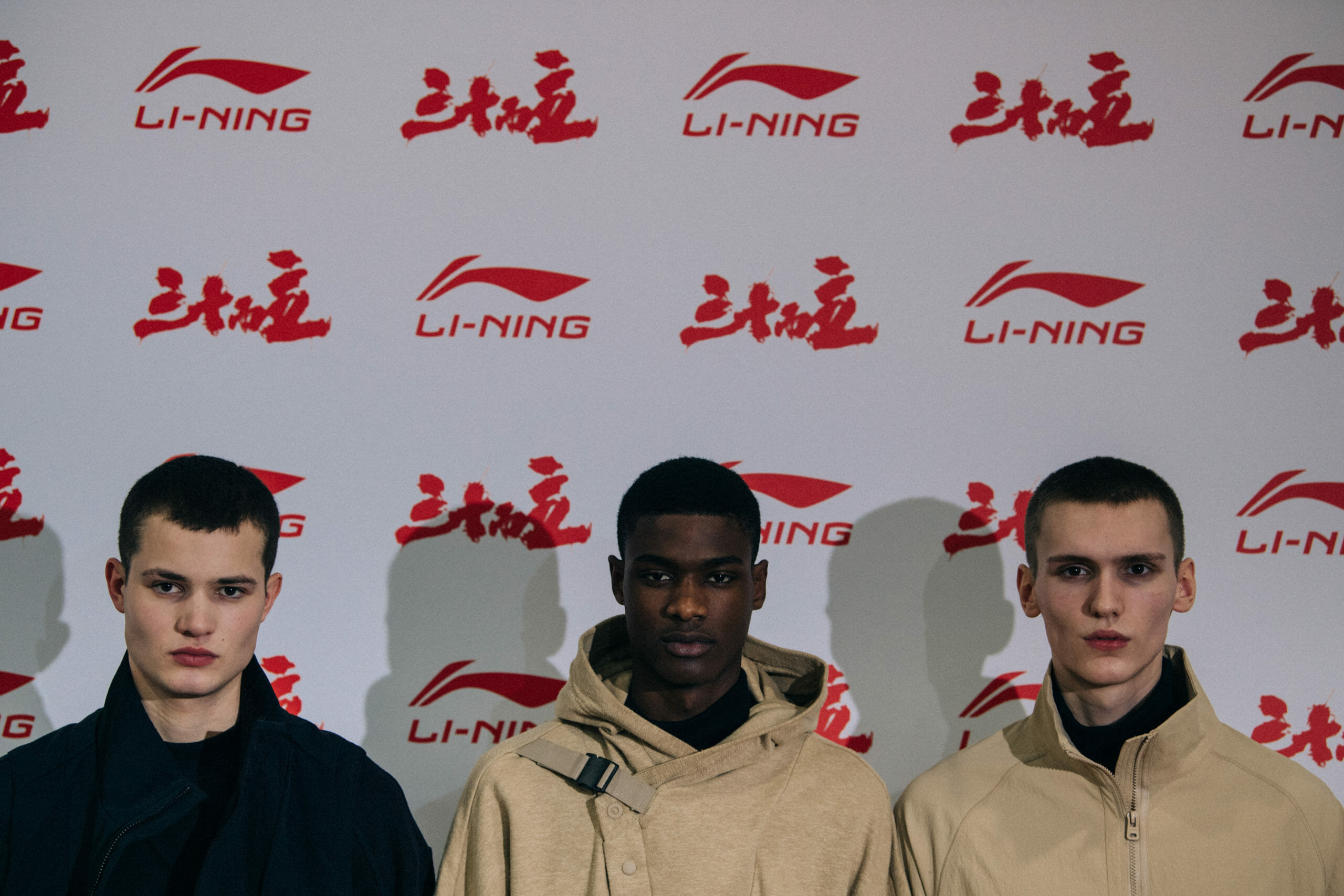 Models wearing tan Li Ning outfit