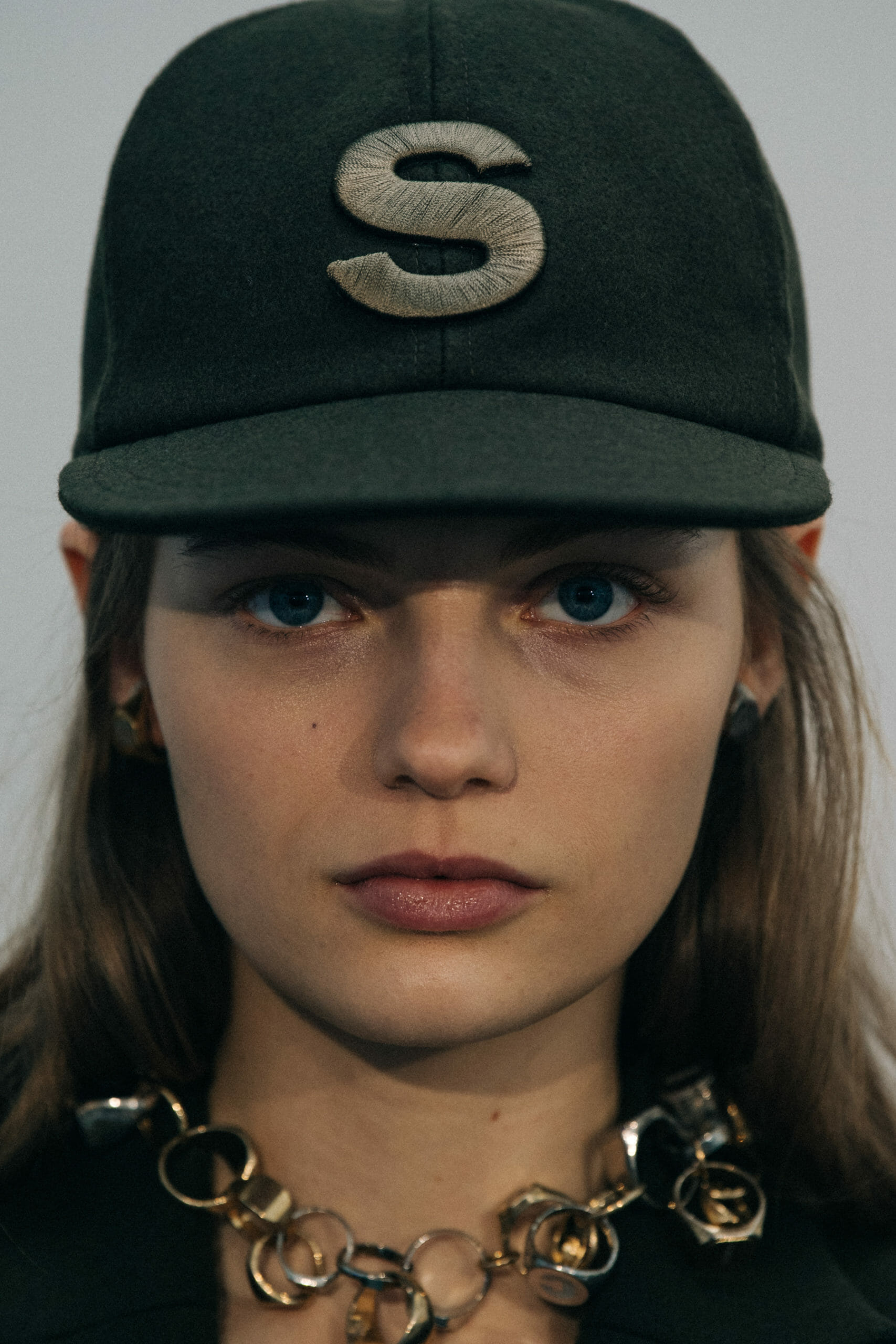 Models wearing Sacai caps