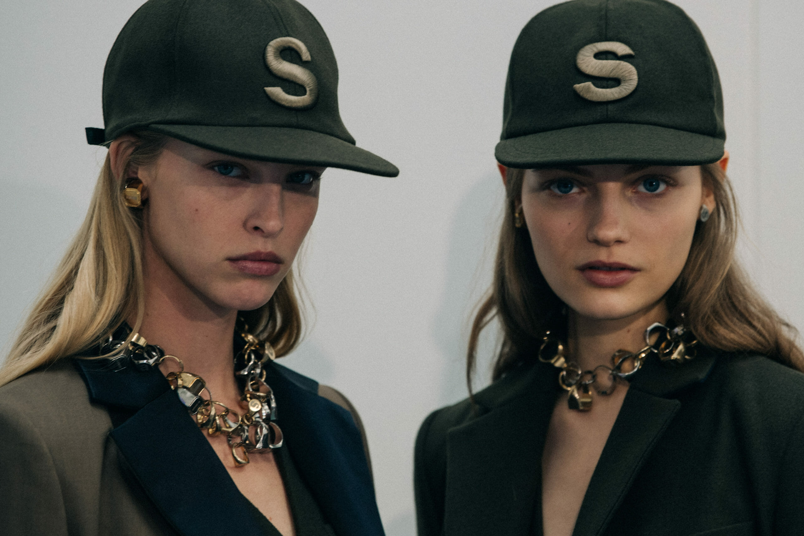 Models wearing Sacai caps