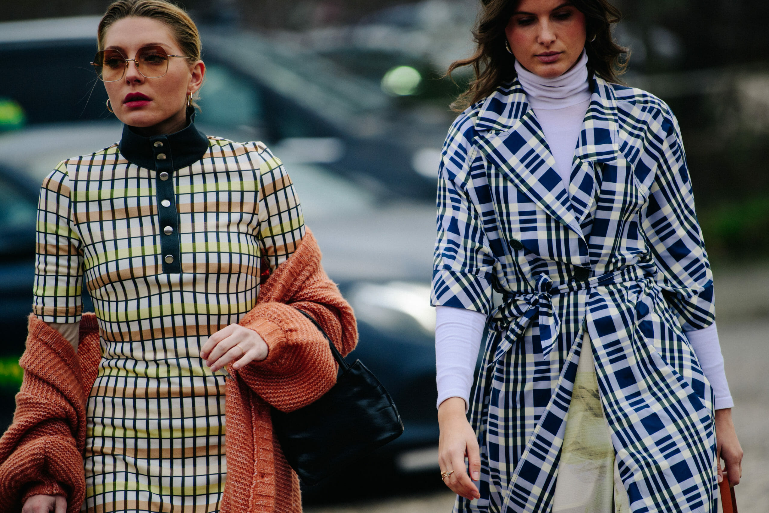 Two women wearing pattern dresses