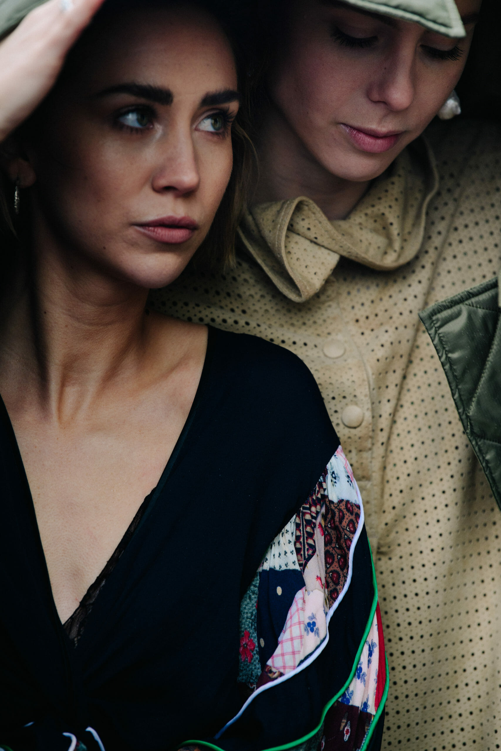 Two women sheltering from rain