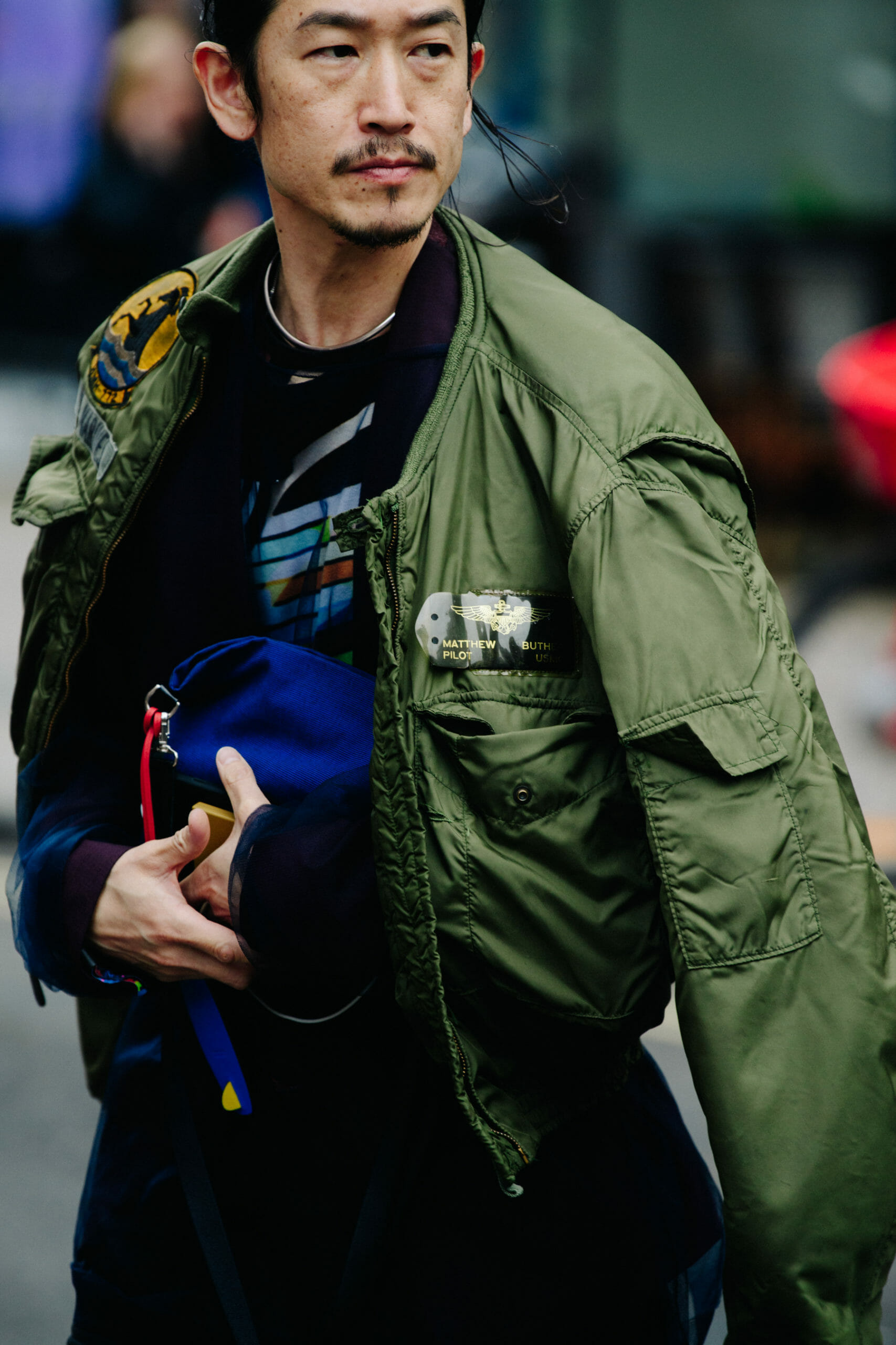 Man wearing green bomber
