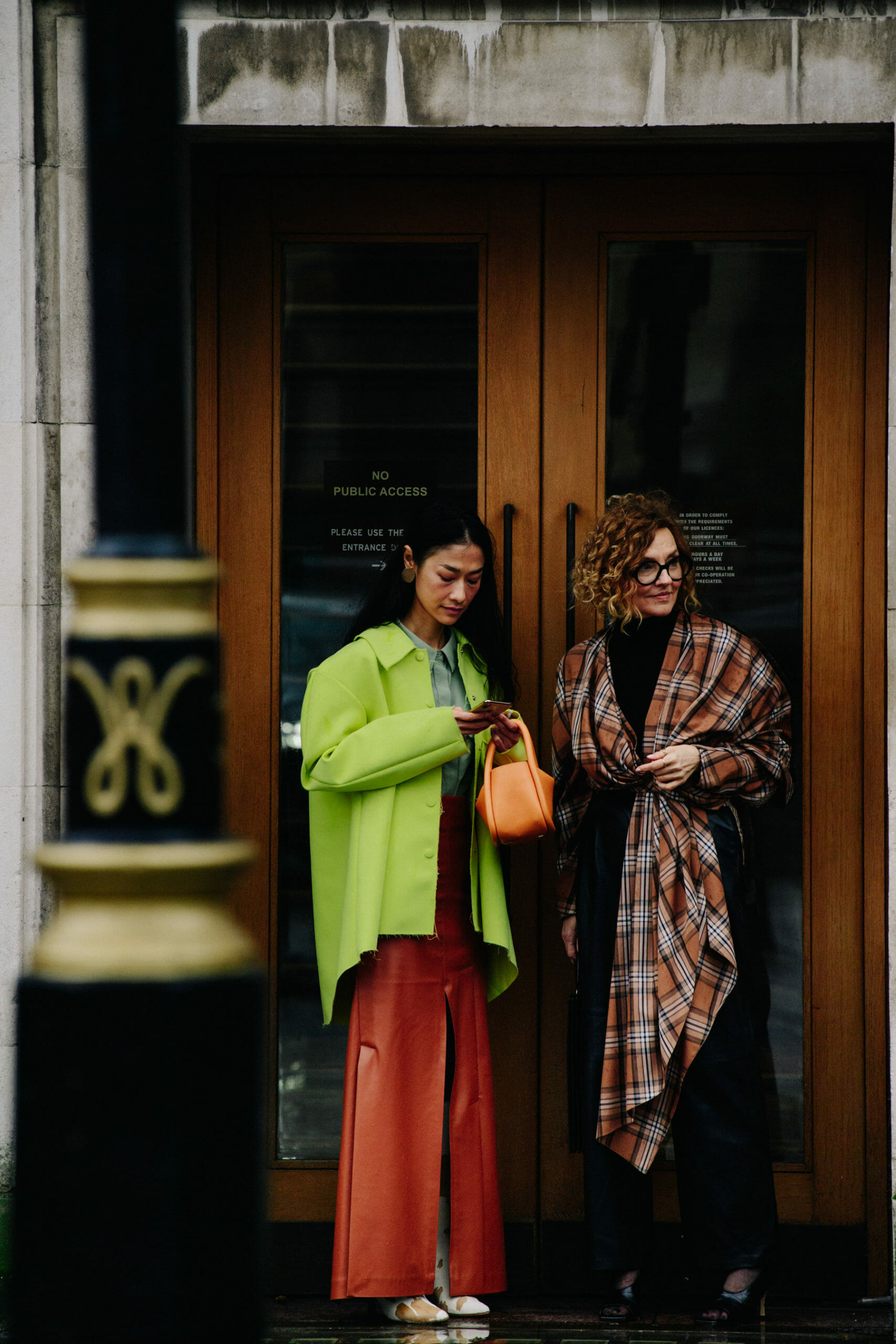 Two women wearing colourful clothing