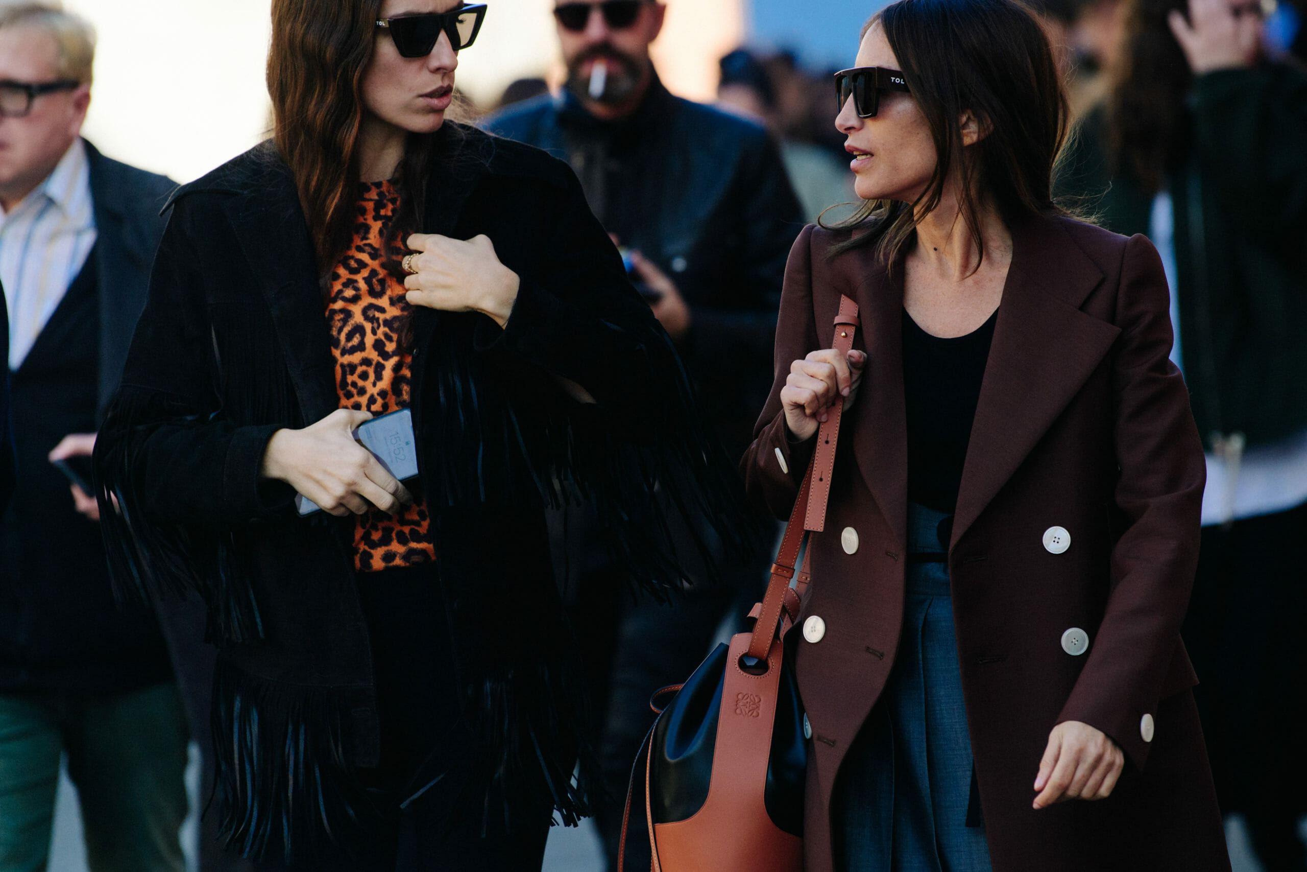 Two women wearing brown