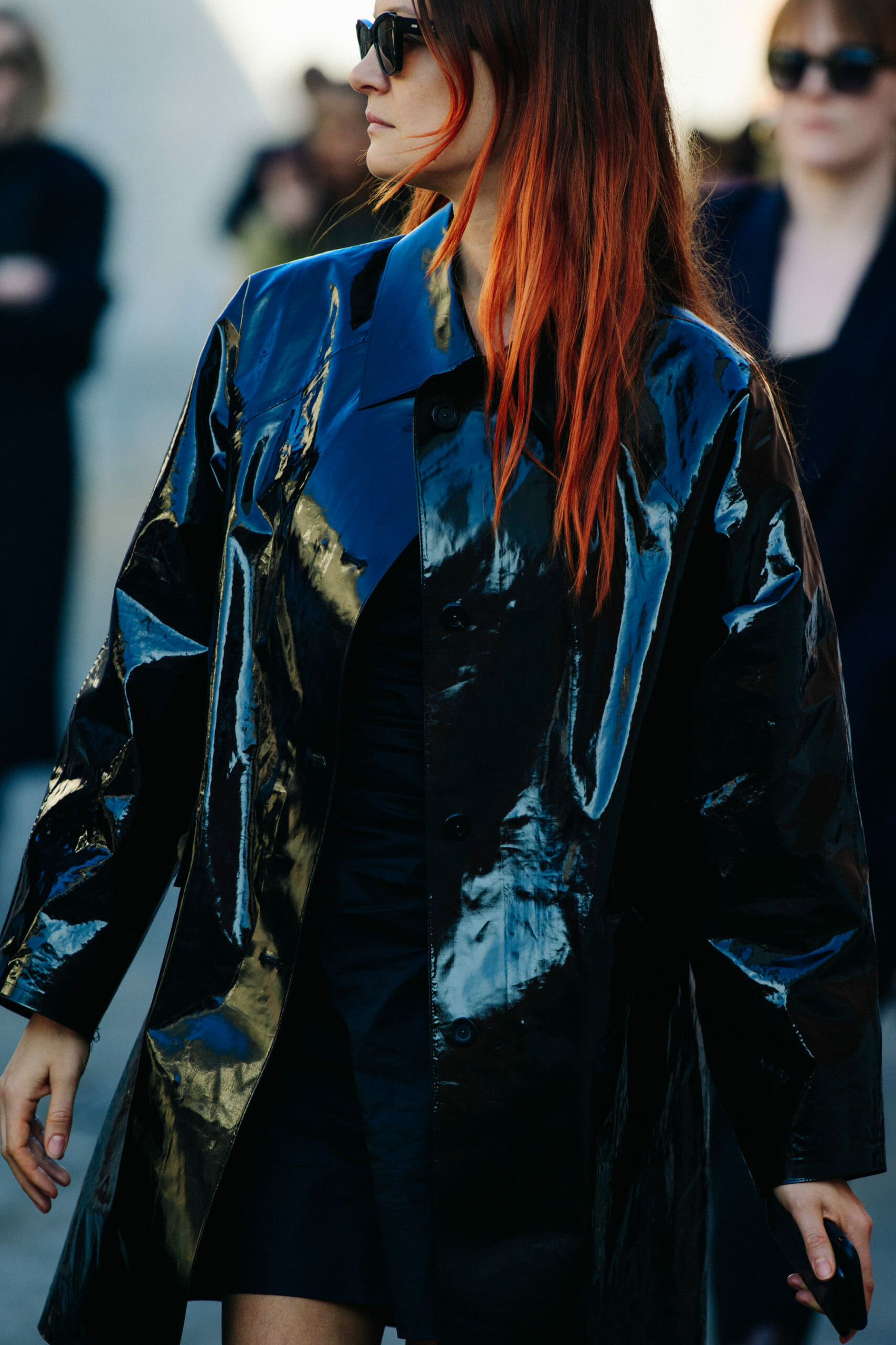 Woman wearing black plastic coat