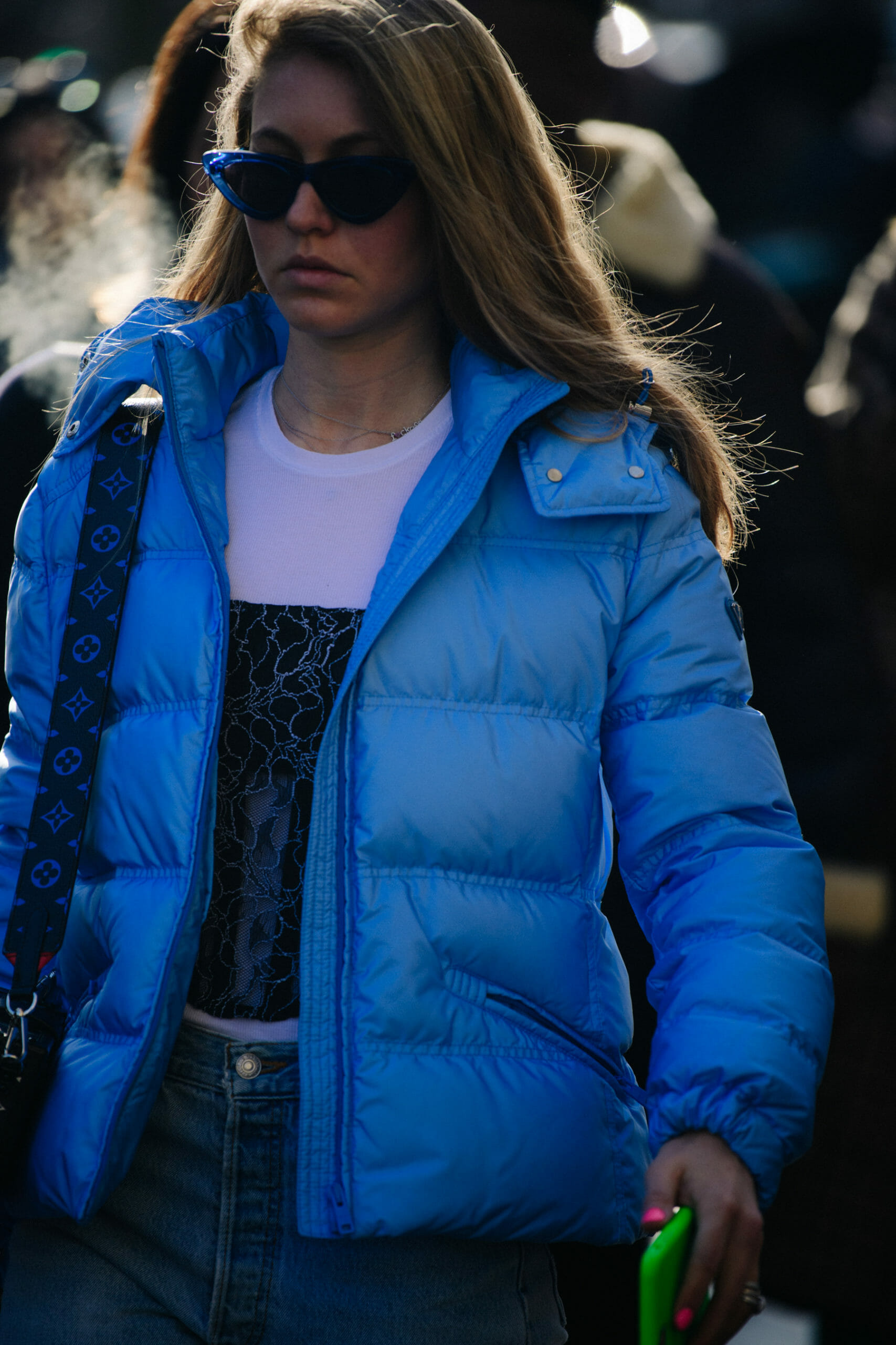 Woman wearing blue Prada jacket