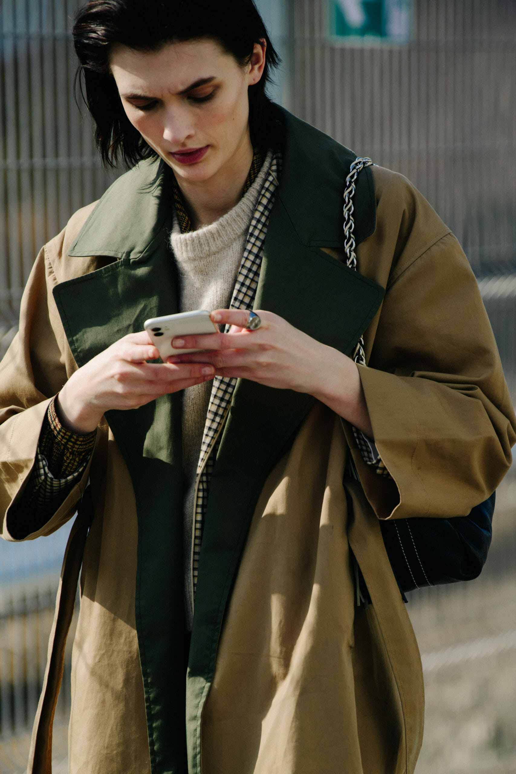 Model wearing tan trench coat