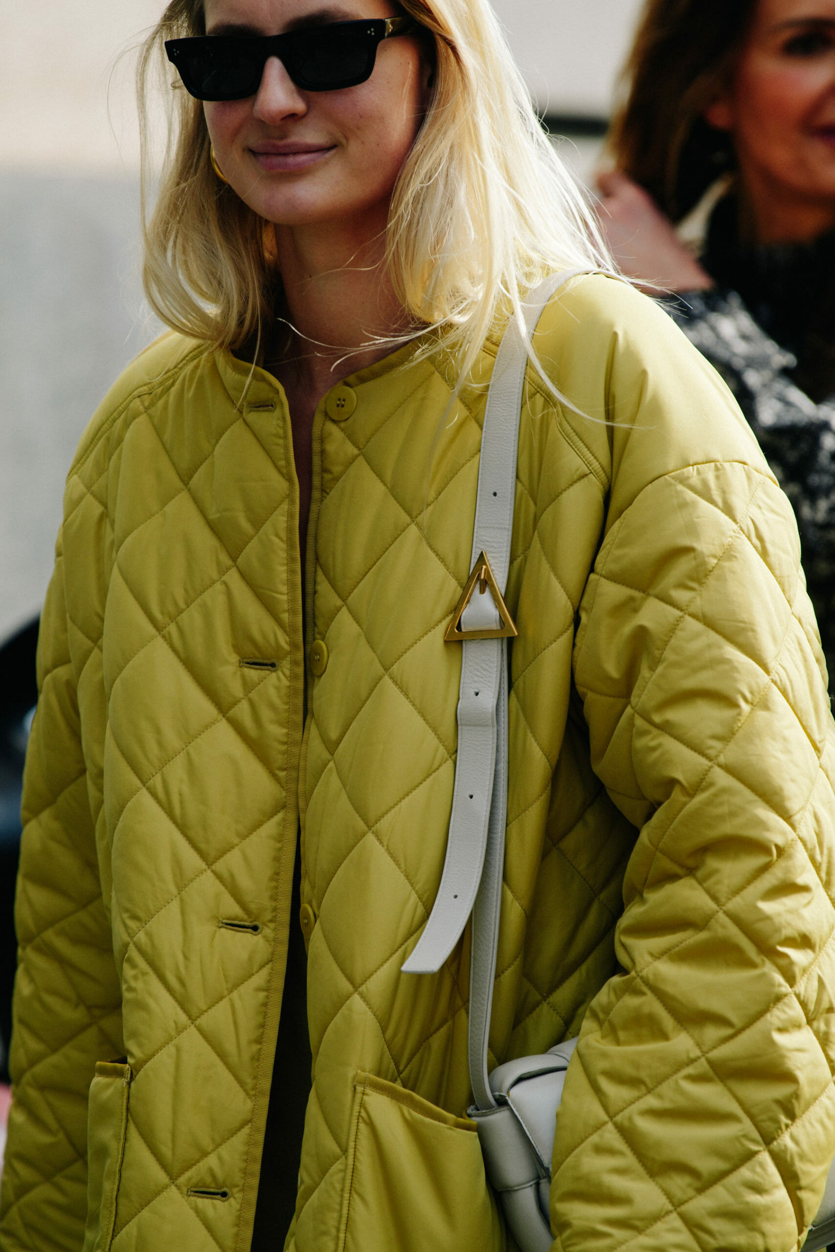 Woman wearing yellow quilted jacket