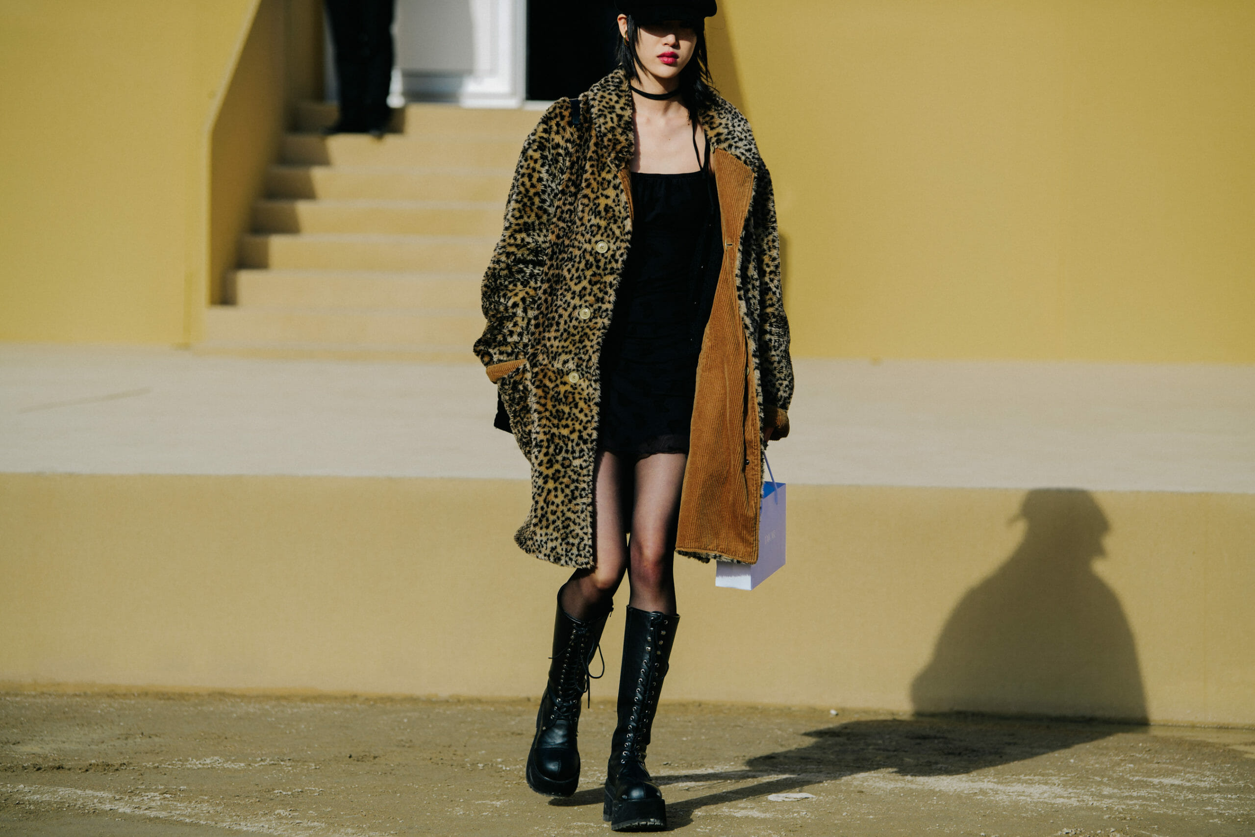Model wearing high boots