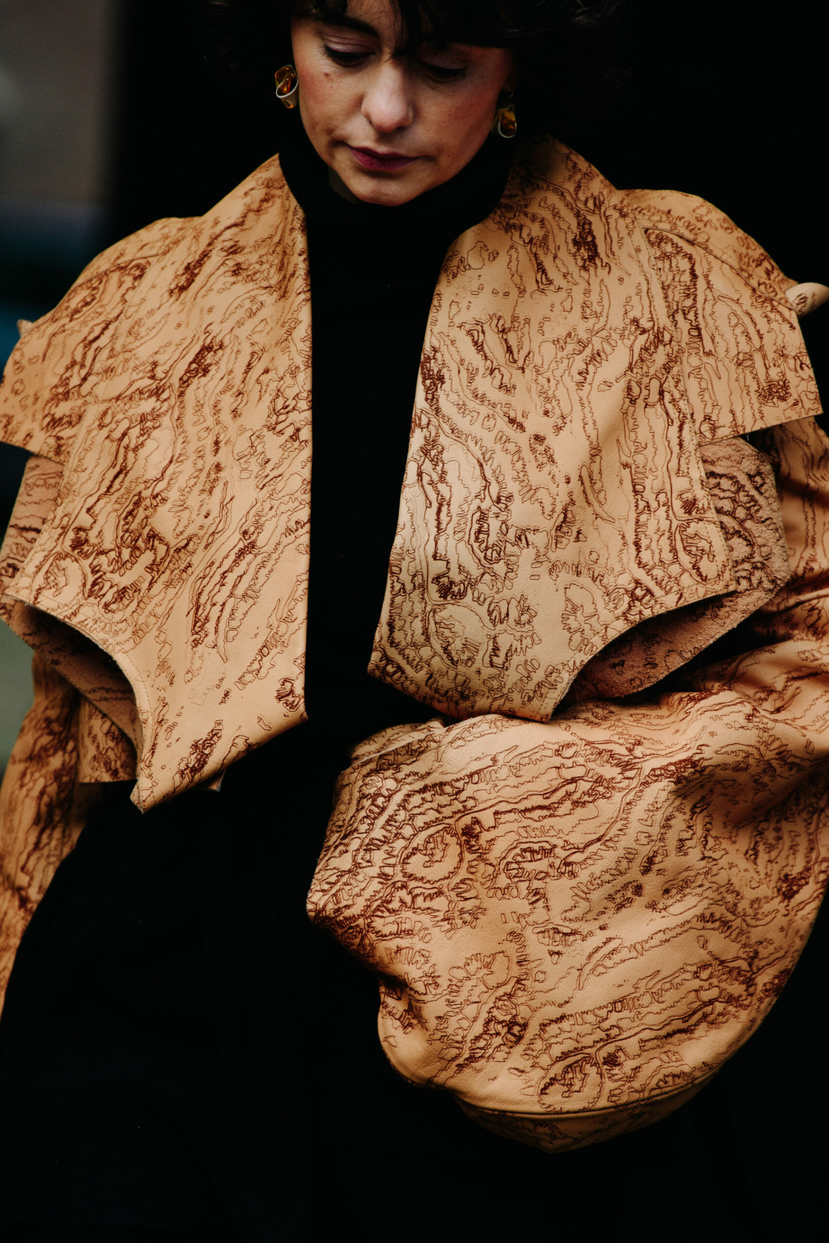 Woman wearing tan jacket