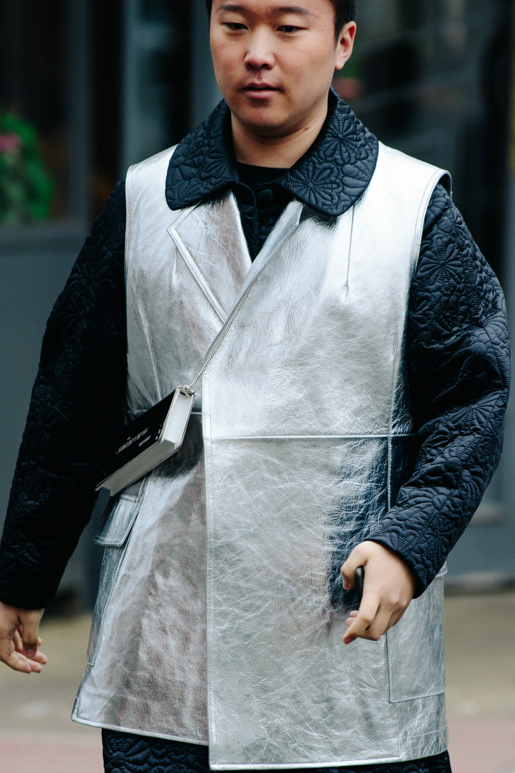 Man wearing silver top