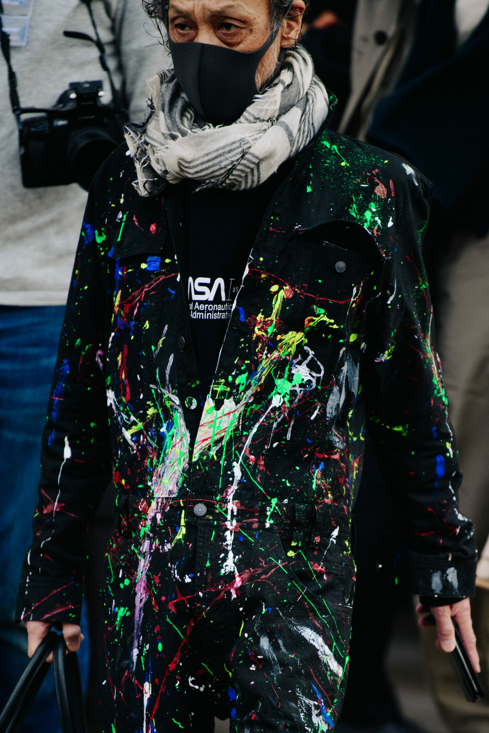 Man wearing paint splattered coat