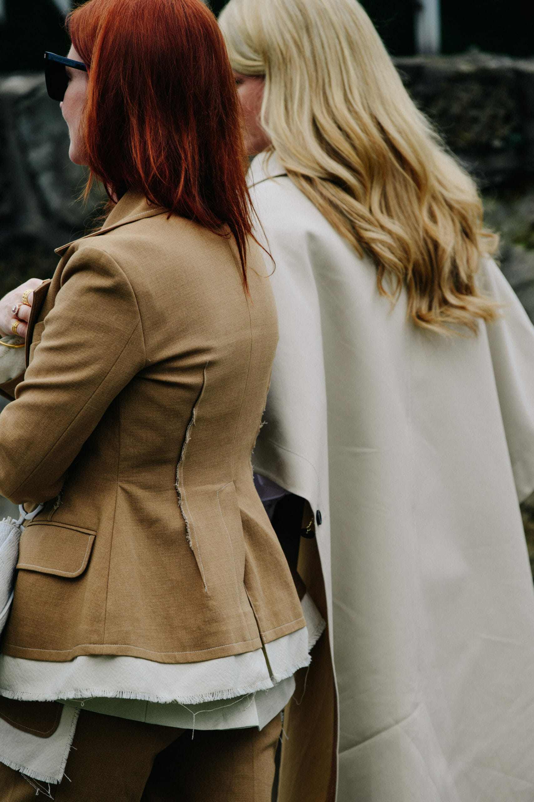Women wearing tan coats
