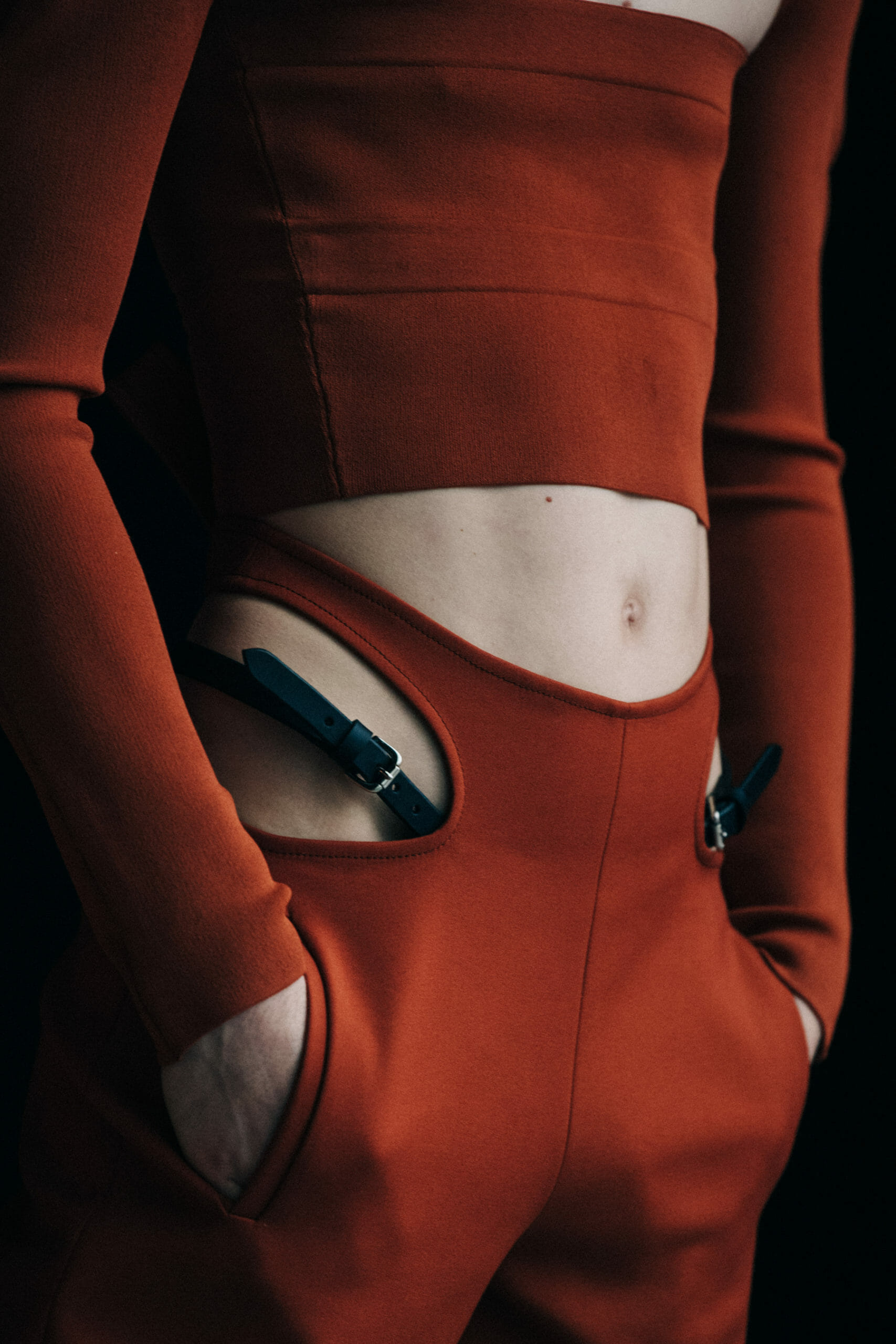 Model wearing orange Dion Lee outfit