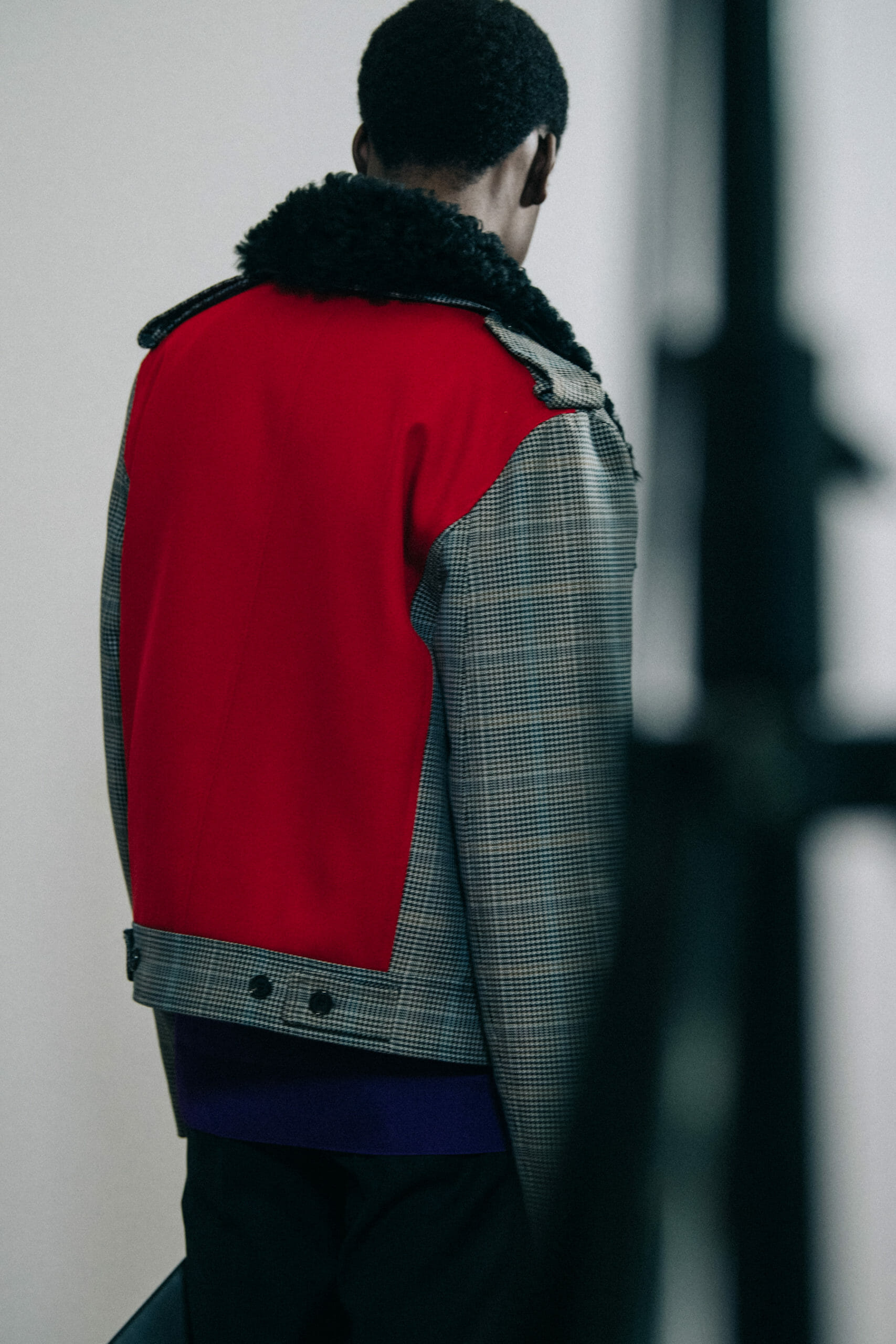 Model wearing grey check jacket