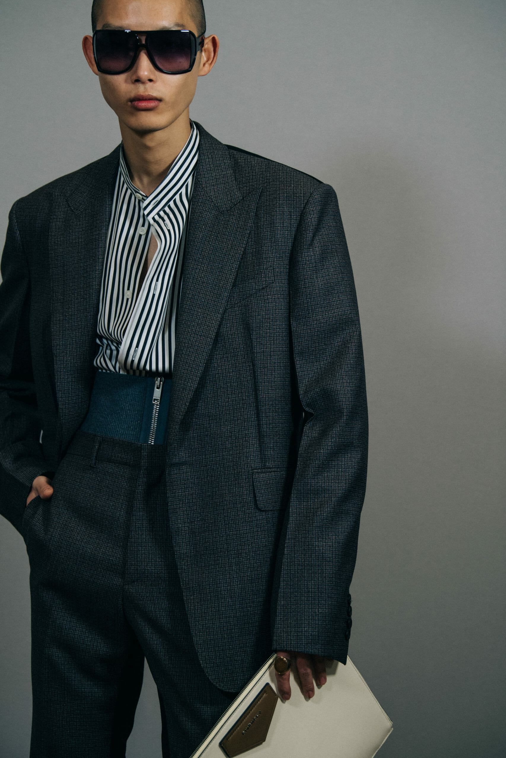 Model wearing grey suit jacket