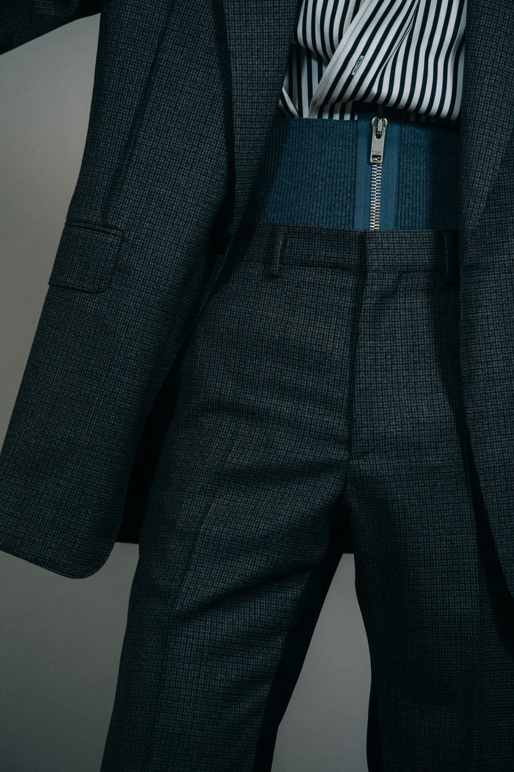 Model wearing grey suit jacket