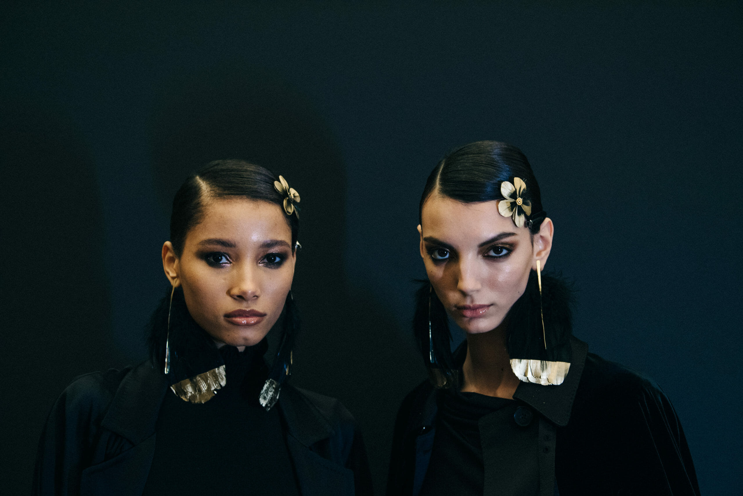 Model wearing feather earrings