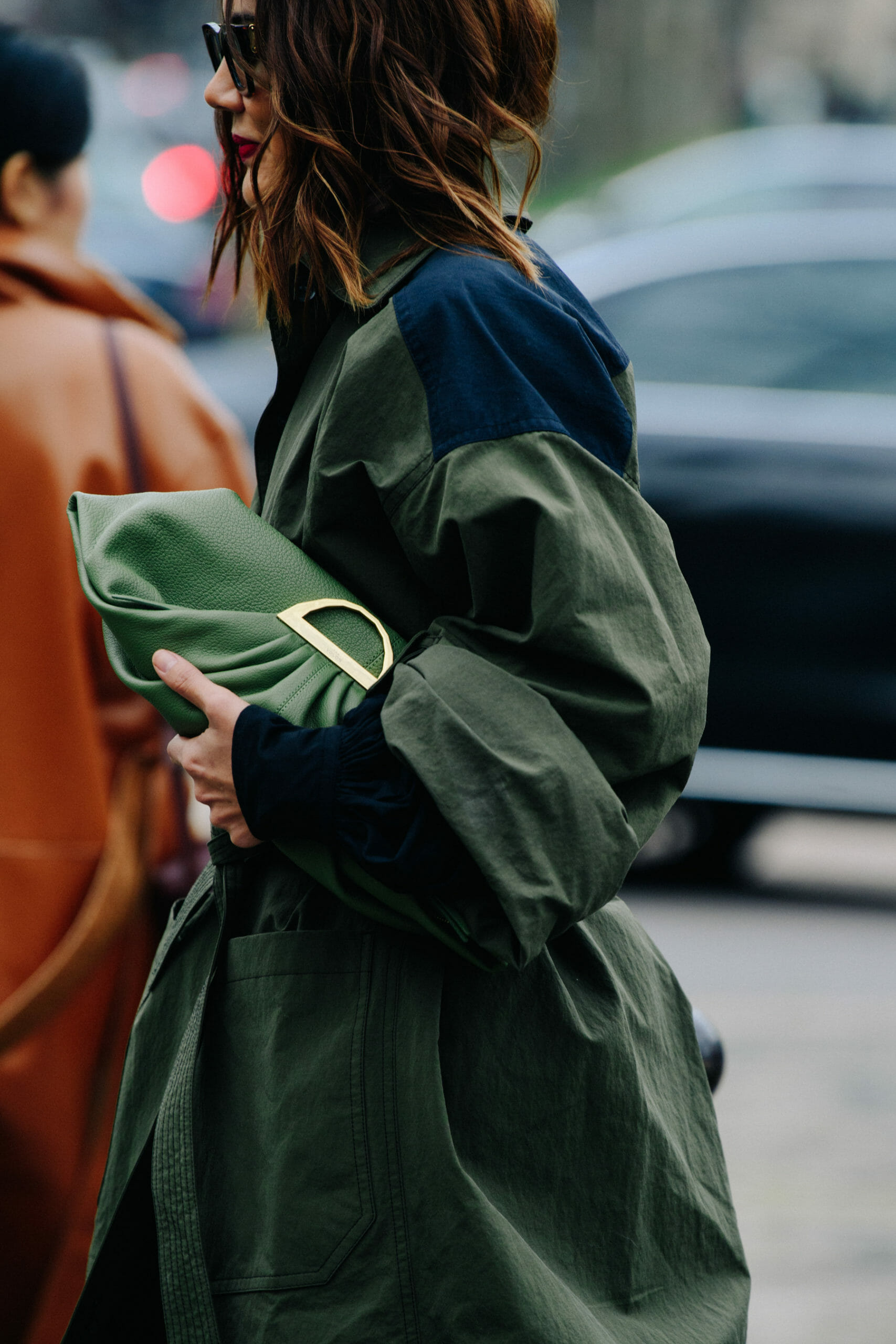 Woman carrying green purse