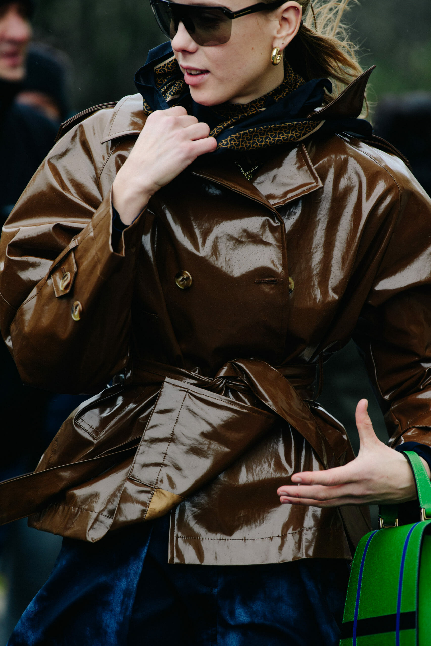 Woman wearing brown plastic coat