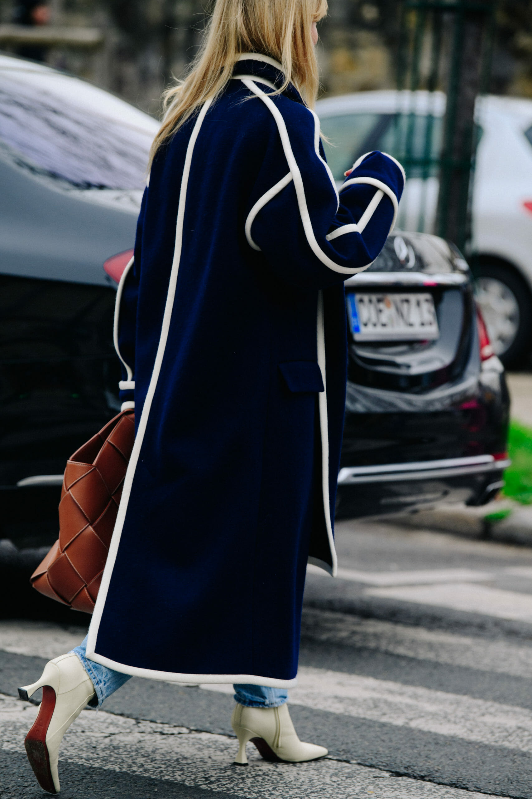 Woman wearing white trim coat
