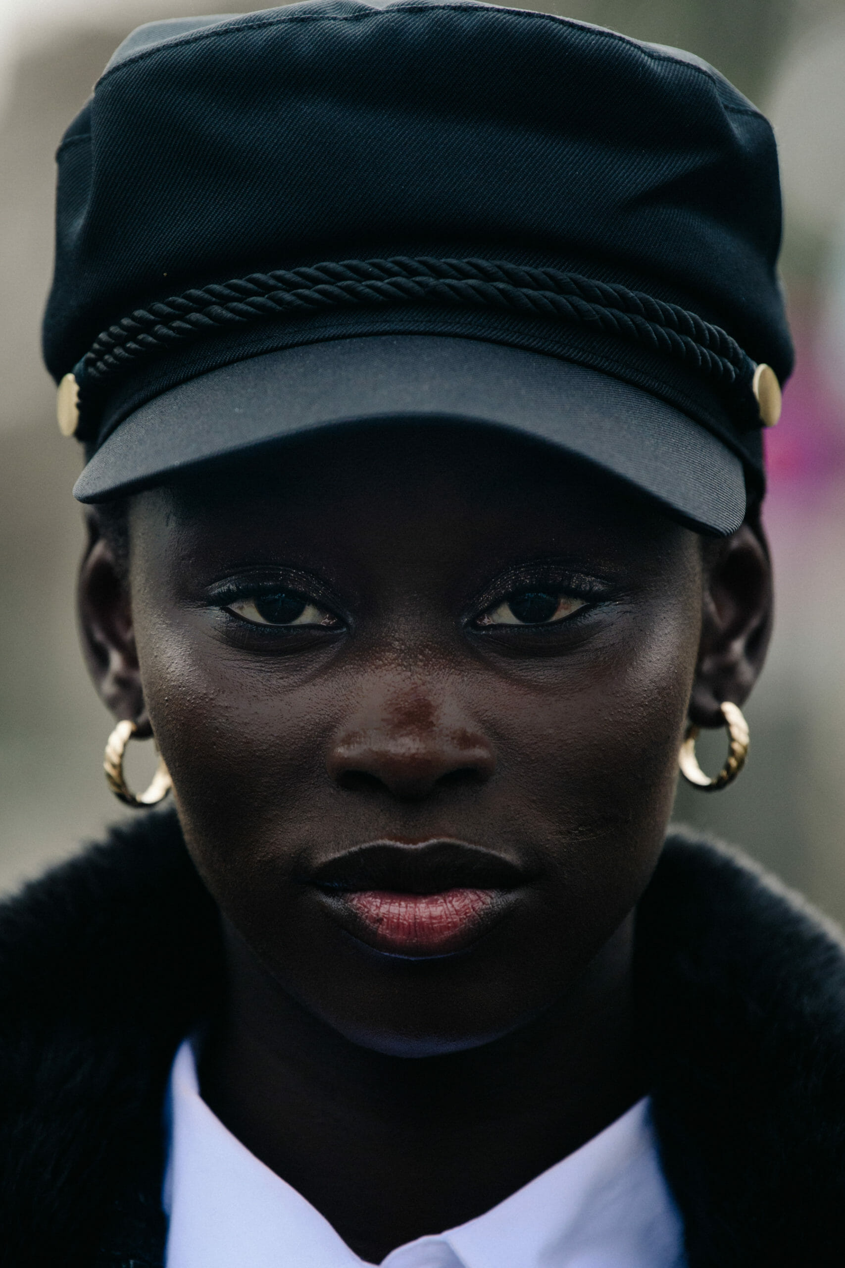 Model wearing black cap