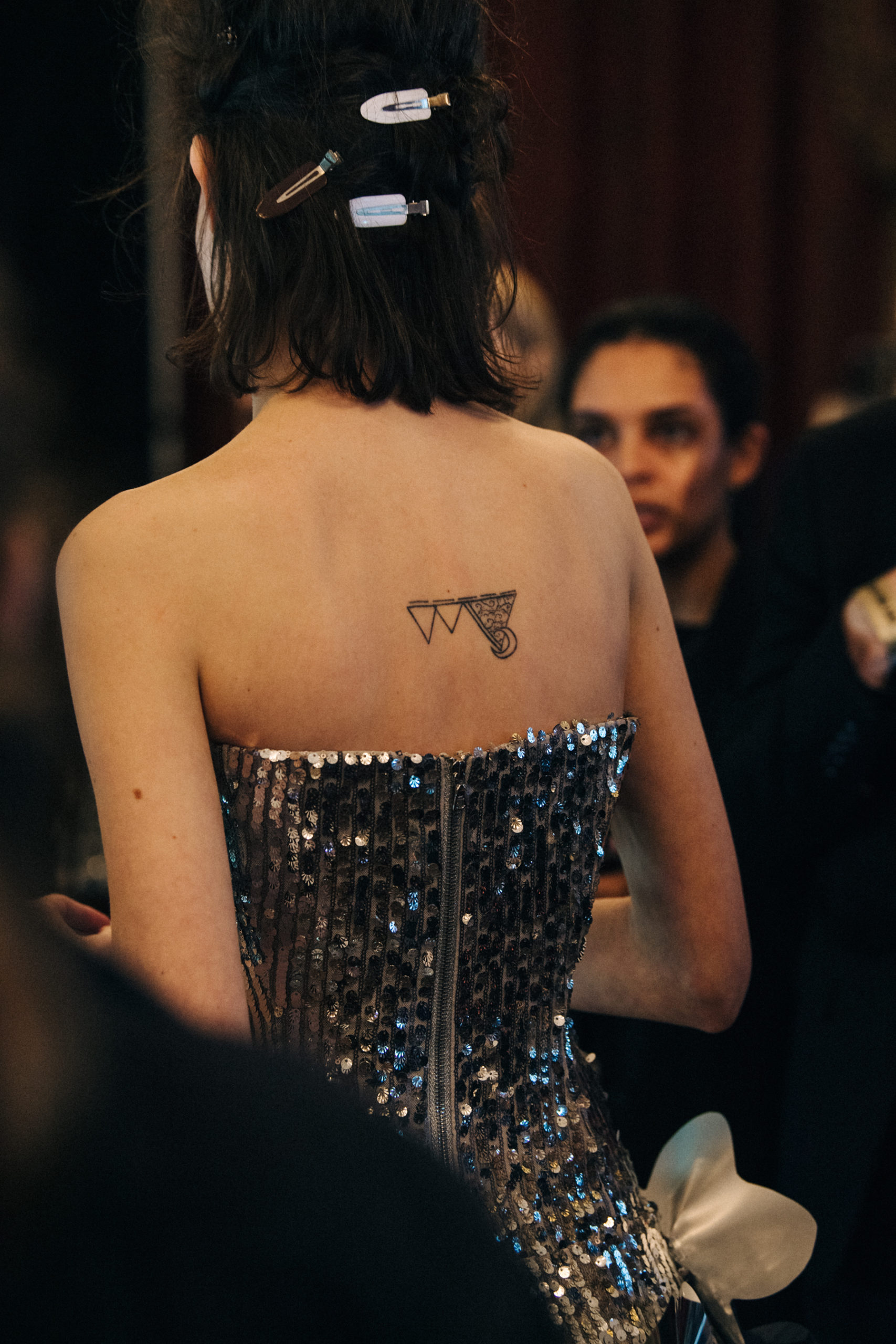 Model wearing silver dress