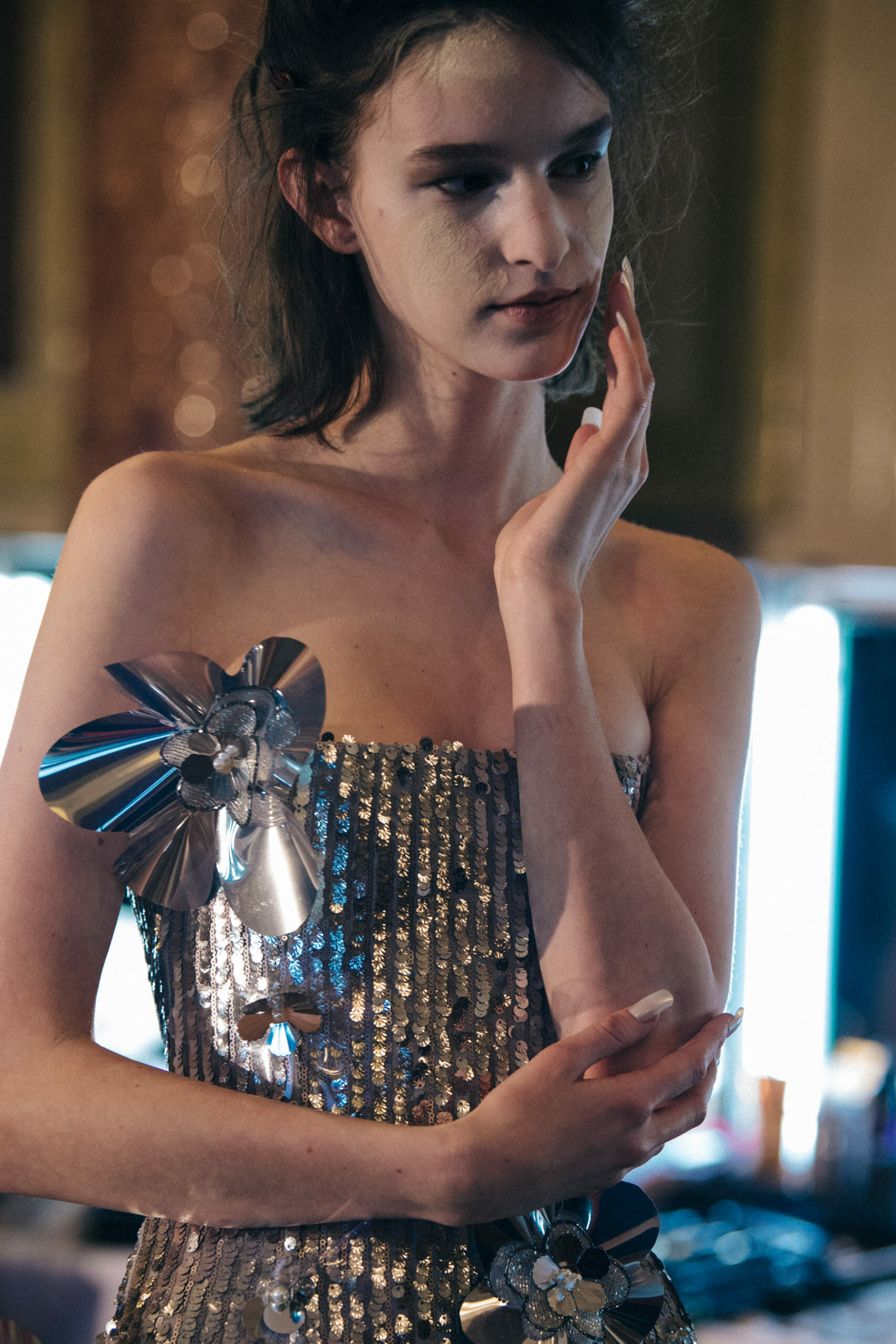 Model wearing silver dress