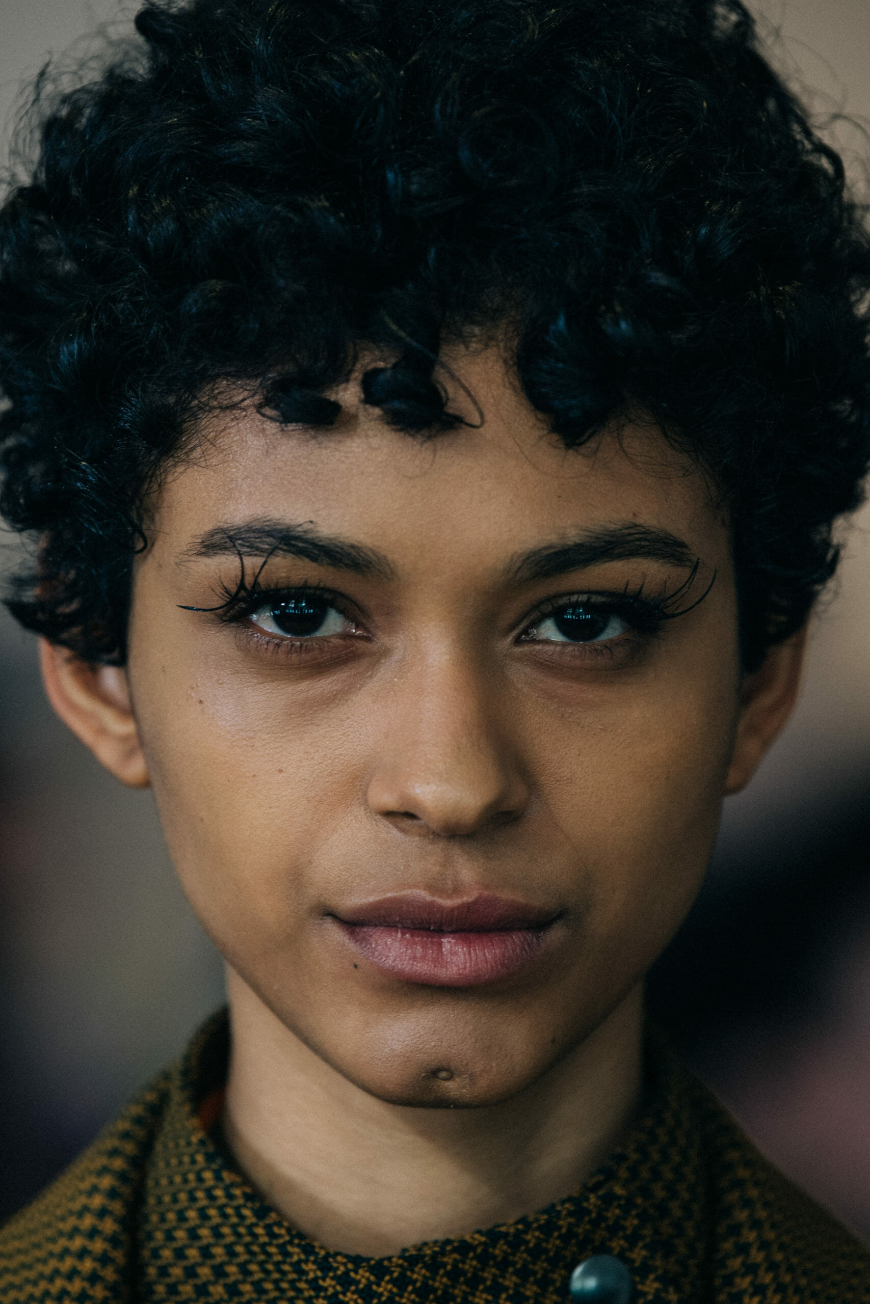 Model with dark curly hair