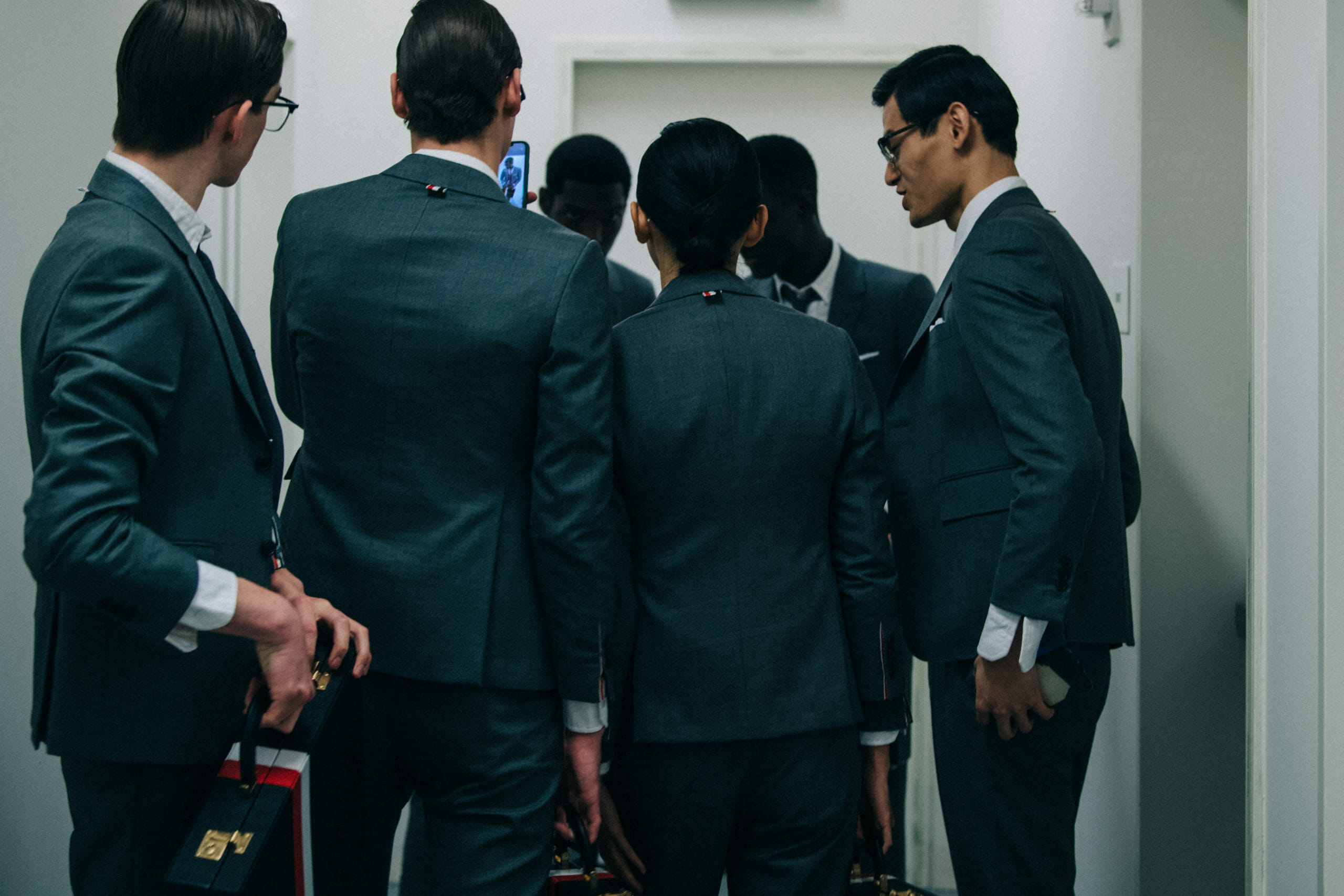Models wearing Thom Browne suit