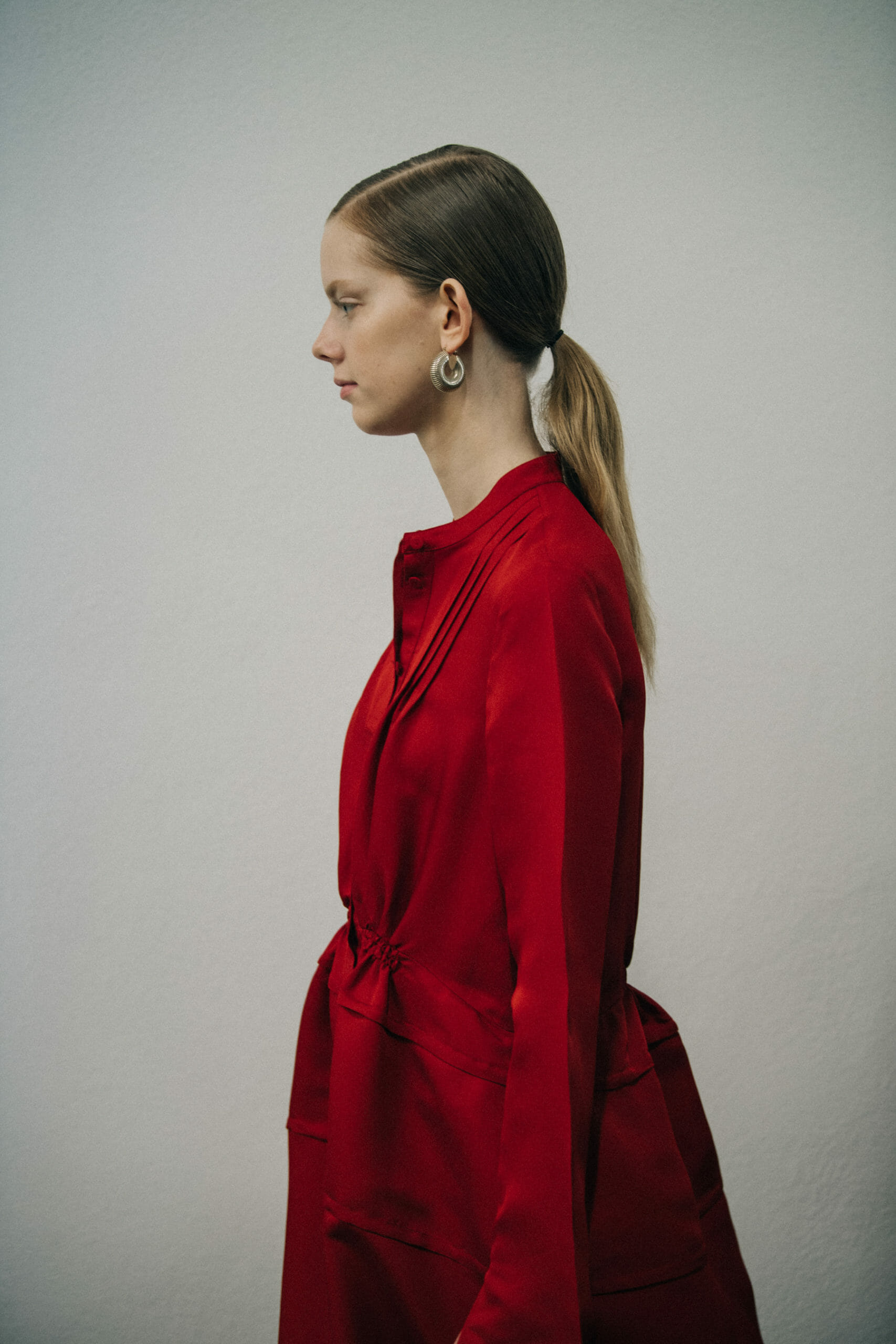 Model wearing red Jil Sander outfit