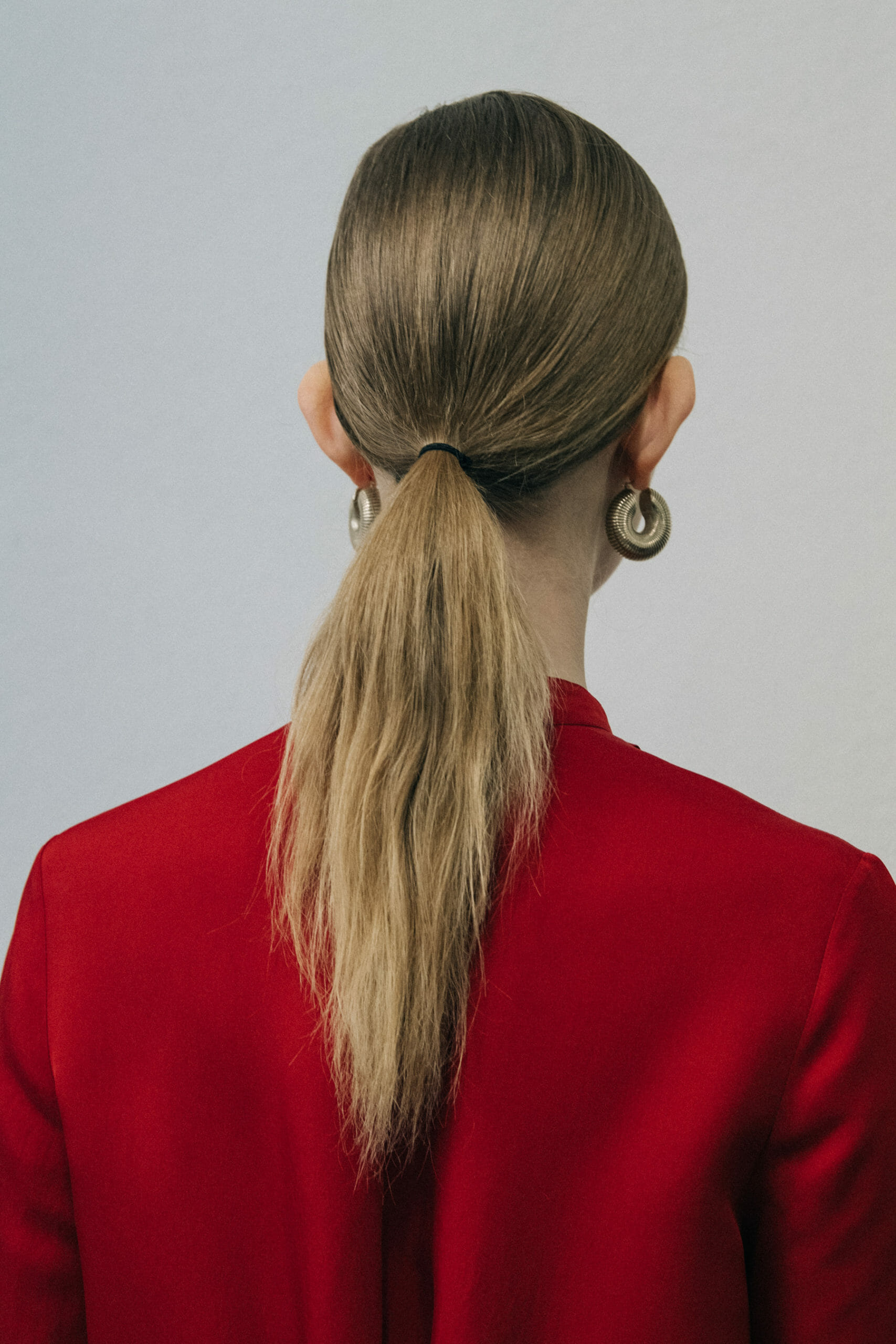 Model wearing red Jil Sander outfit